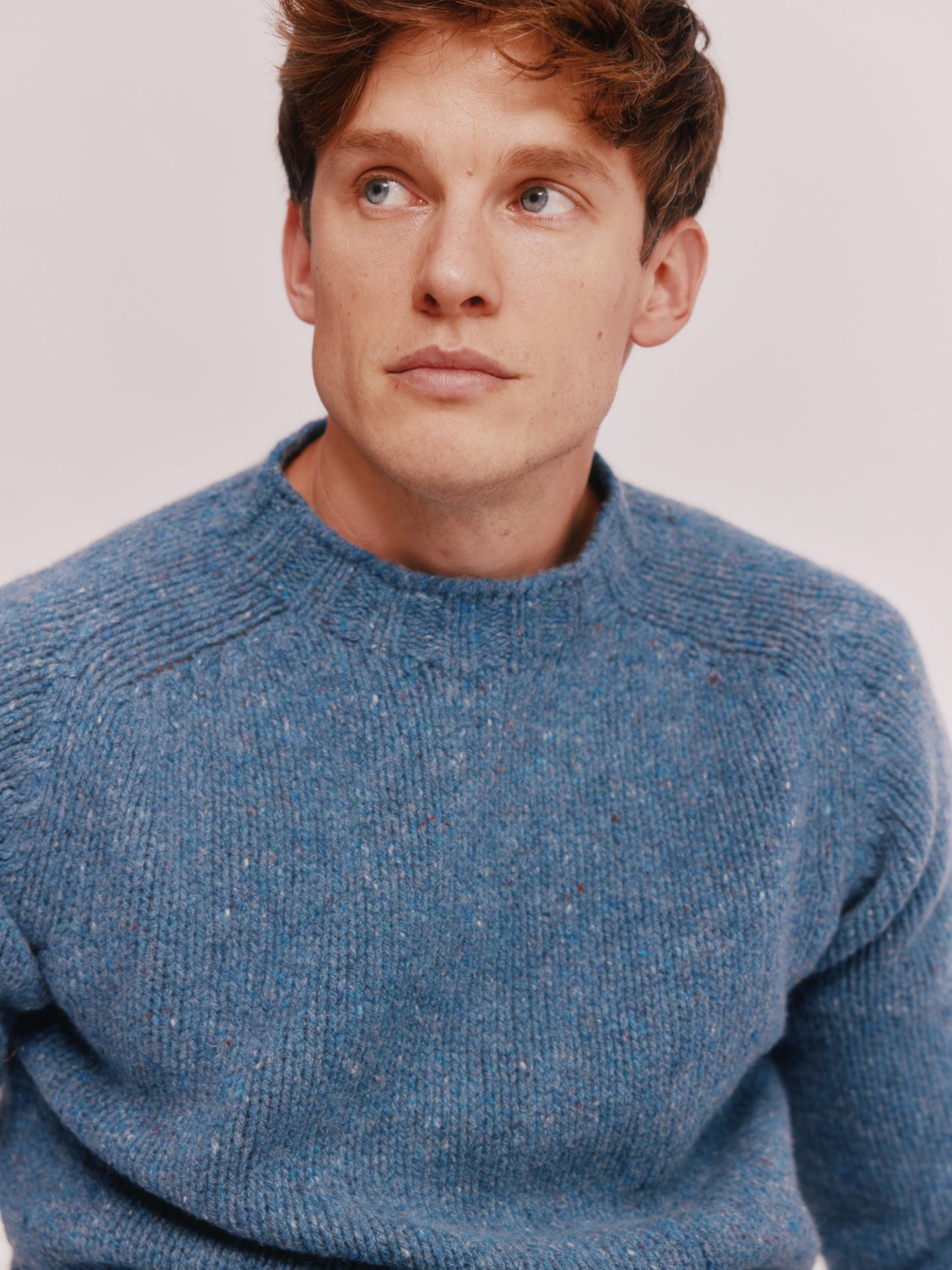 Model wearing a Bosie Knitwear Blue Mogganer Trawlerman Chunky Glenugie Nep Sweater in colour Ossian Blue.