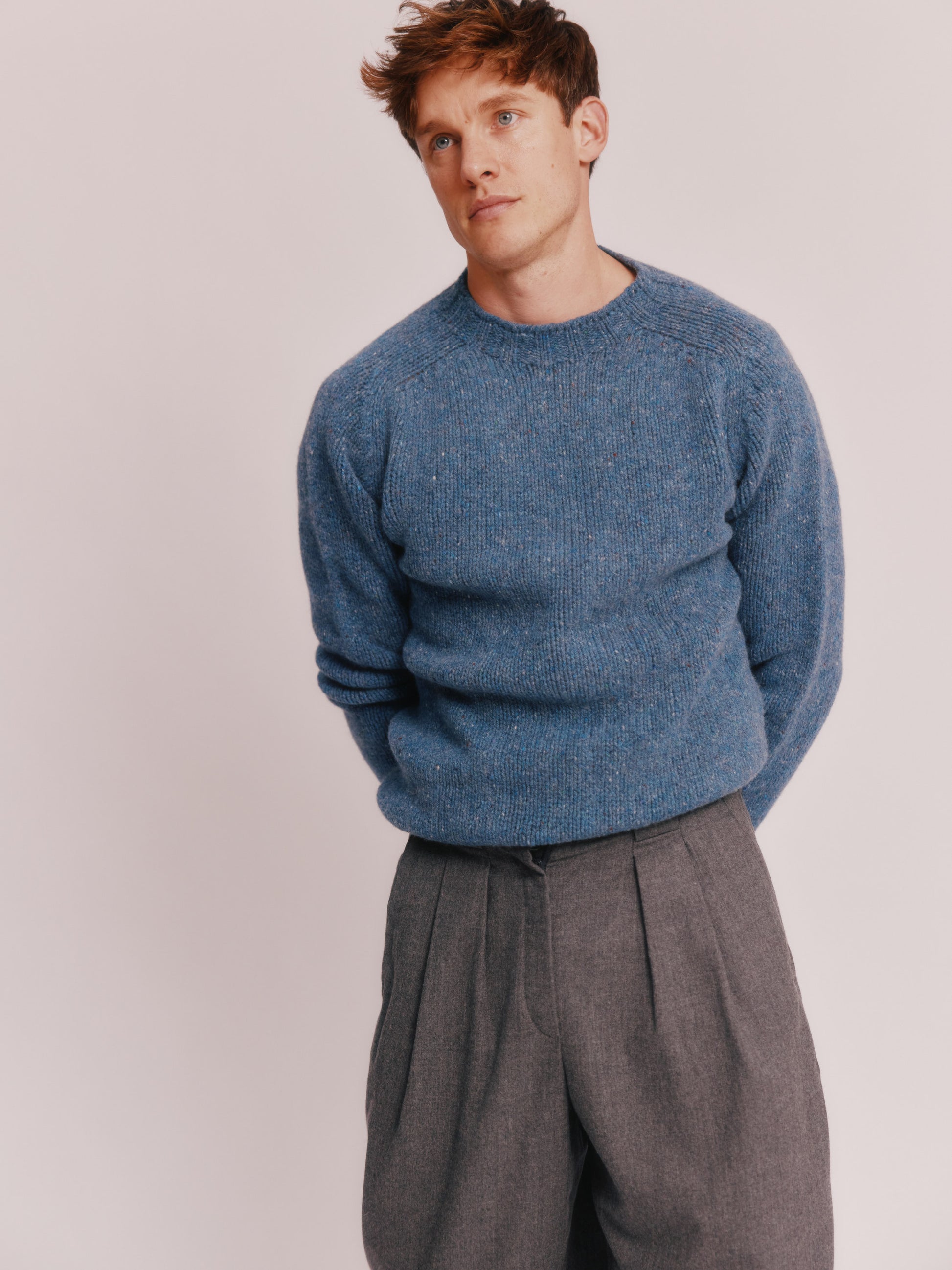Model wearing a Bosie Knitwear Blue Mogganer Trawlerman Chunky Glenugie Nep Sweater in colour Ossian Blue.