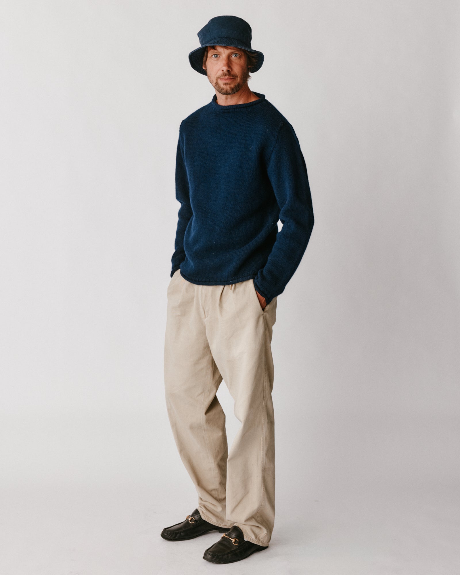 A model wearing a Bosie Blue Mogganer Whaler Rolled Neck Chunky Sweater in colour Navy.