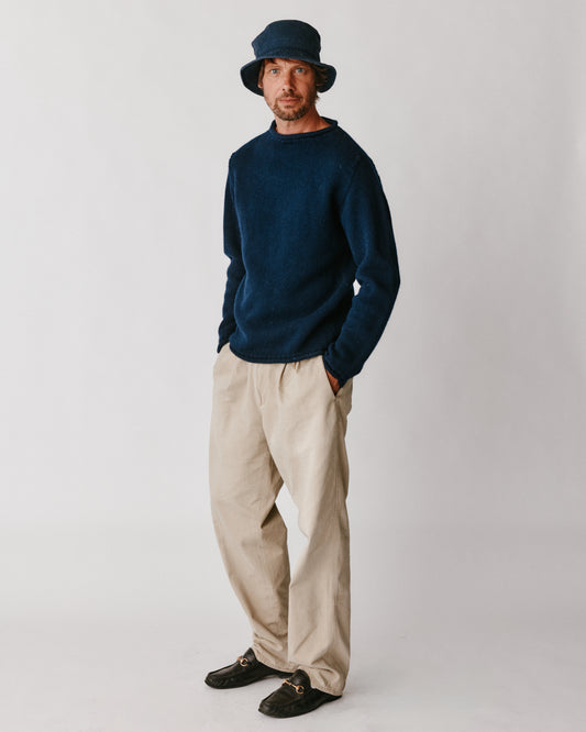 A model wearing a Bosie Blue Mogganer Whaler Rolled Neck Chunky Sweater in colour Navy.