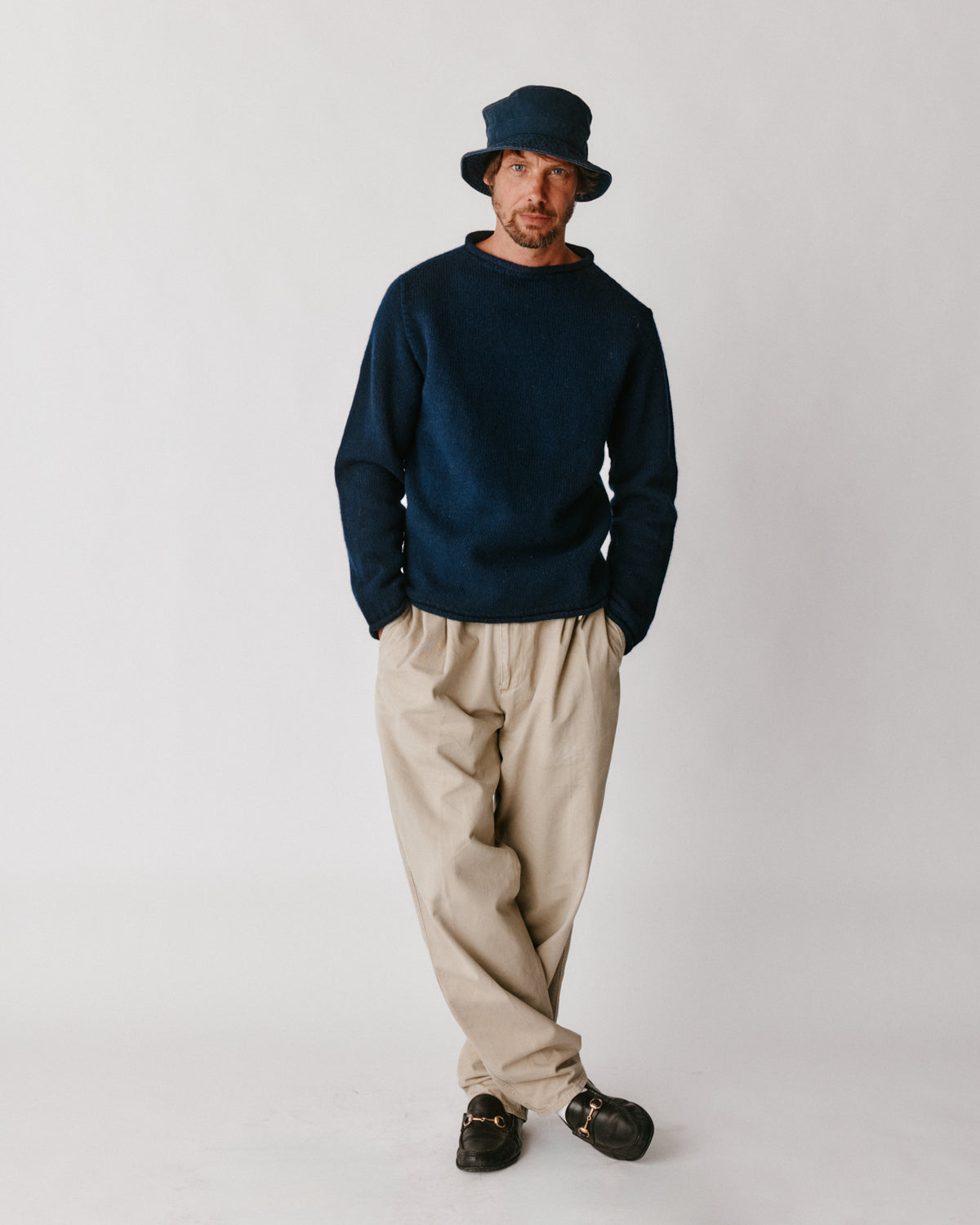 A model wearing a Bosie Blue Mogganer Whaler Rolled Neck Chunky Sweater in colour Navy.