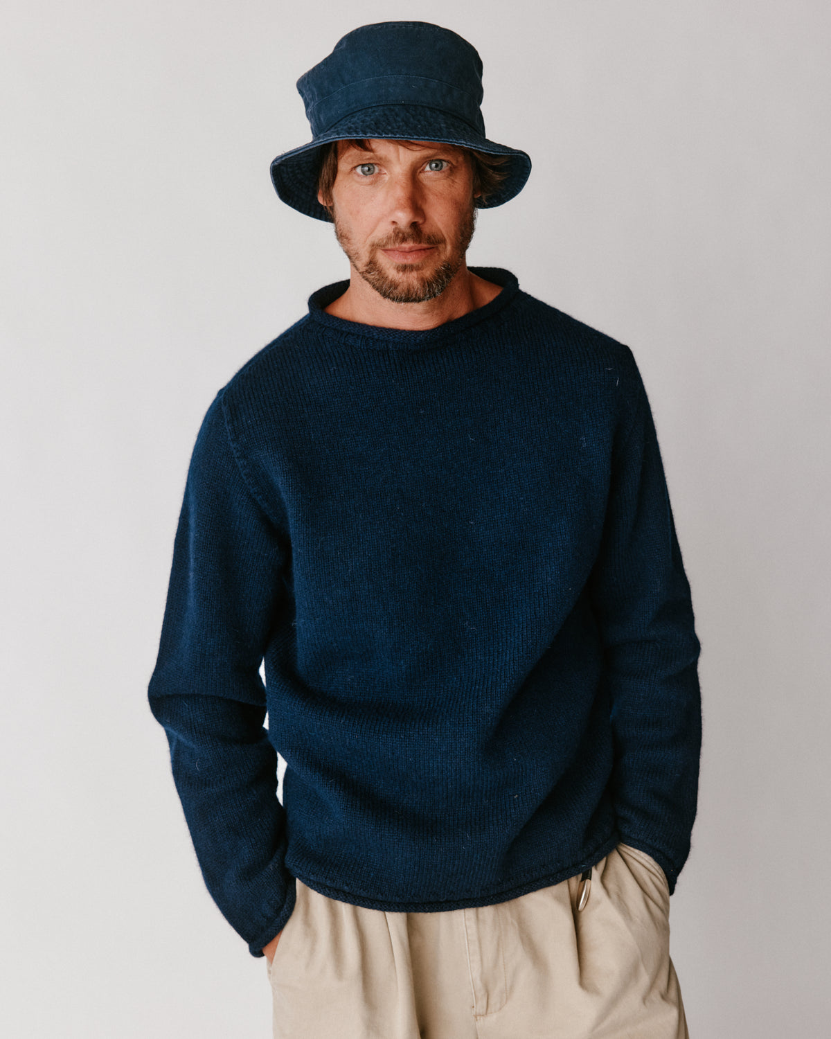 A model wearing a Bosie Blue Mogganer Whaler Rolled Neck Chunky Sweater in colour Navy.