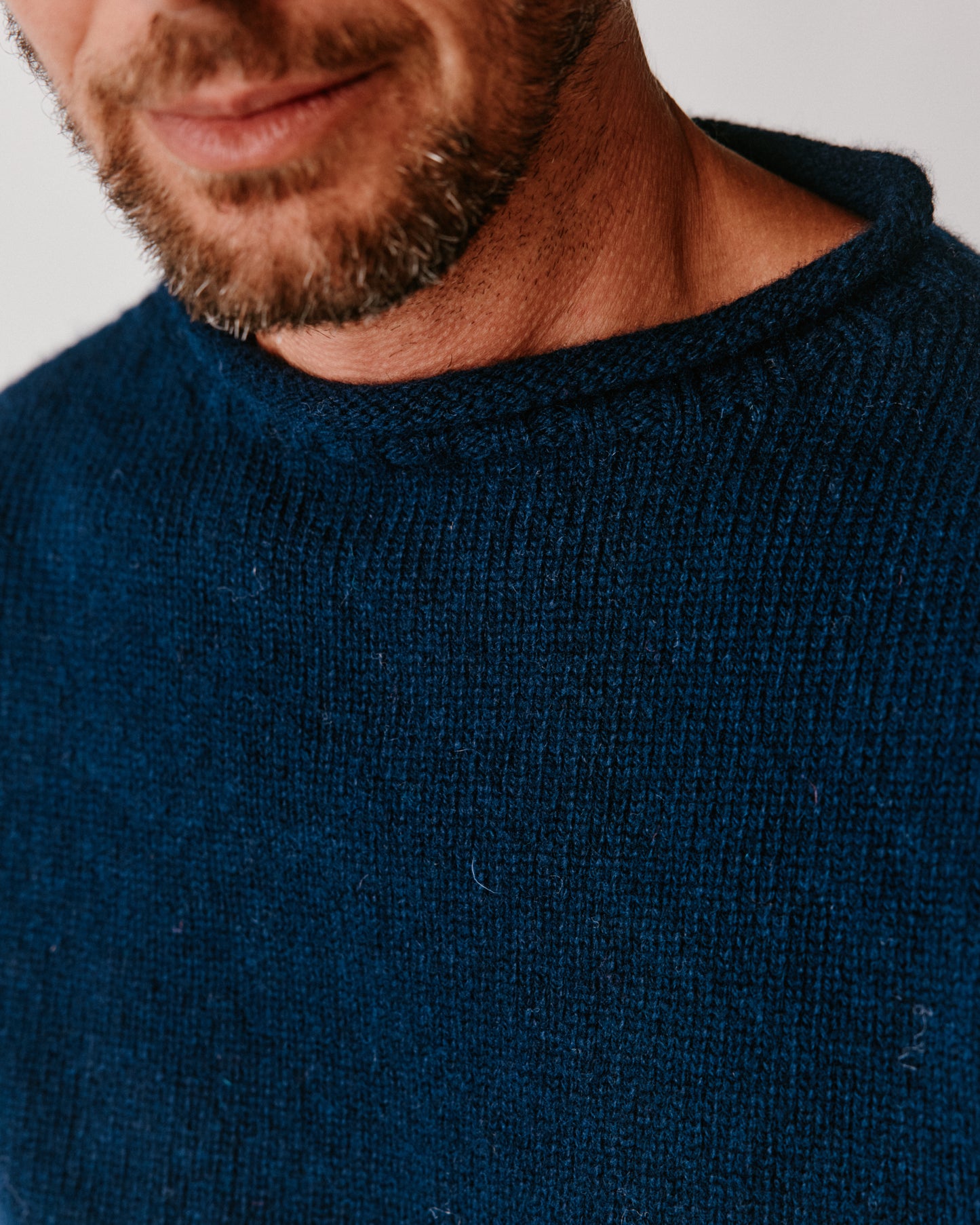 A model wearing a Bosie Blue Mogganer Whaler Rolled Neck Chunky Sweater in colour Navy.