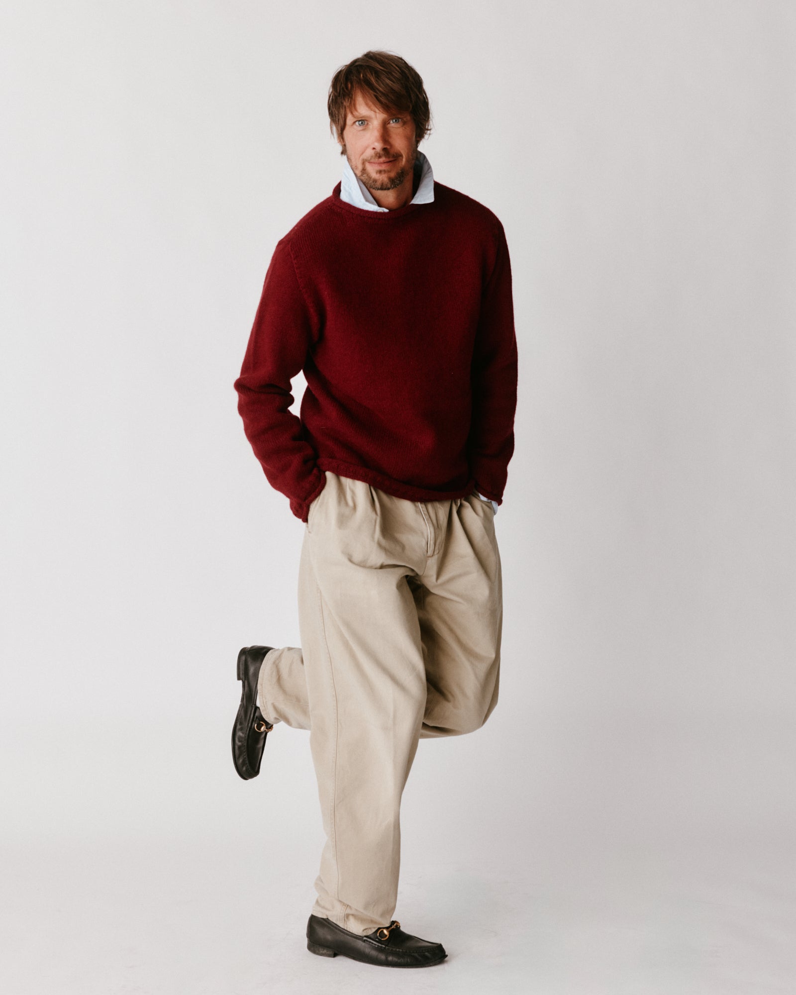 A model wearing a Bosie Blue Mogganer Whaler Rolled Neck Chunky Sweater in colour Claret / Bordeaux Mix.