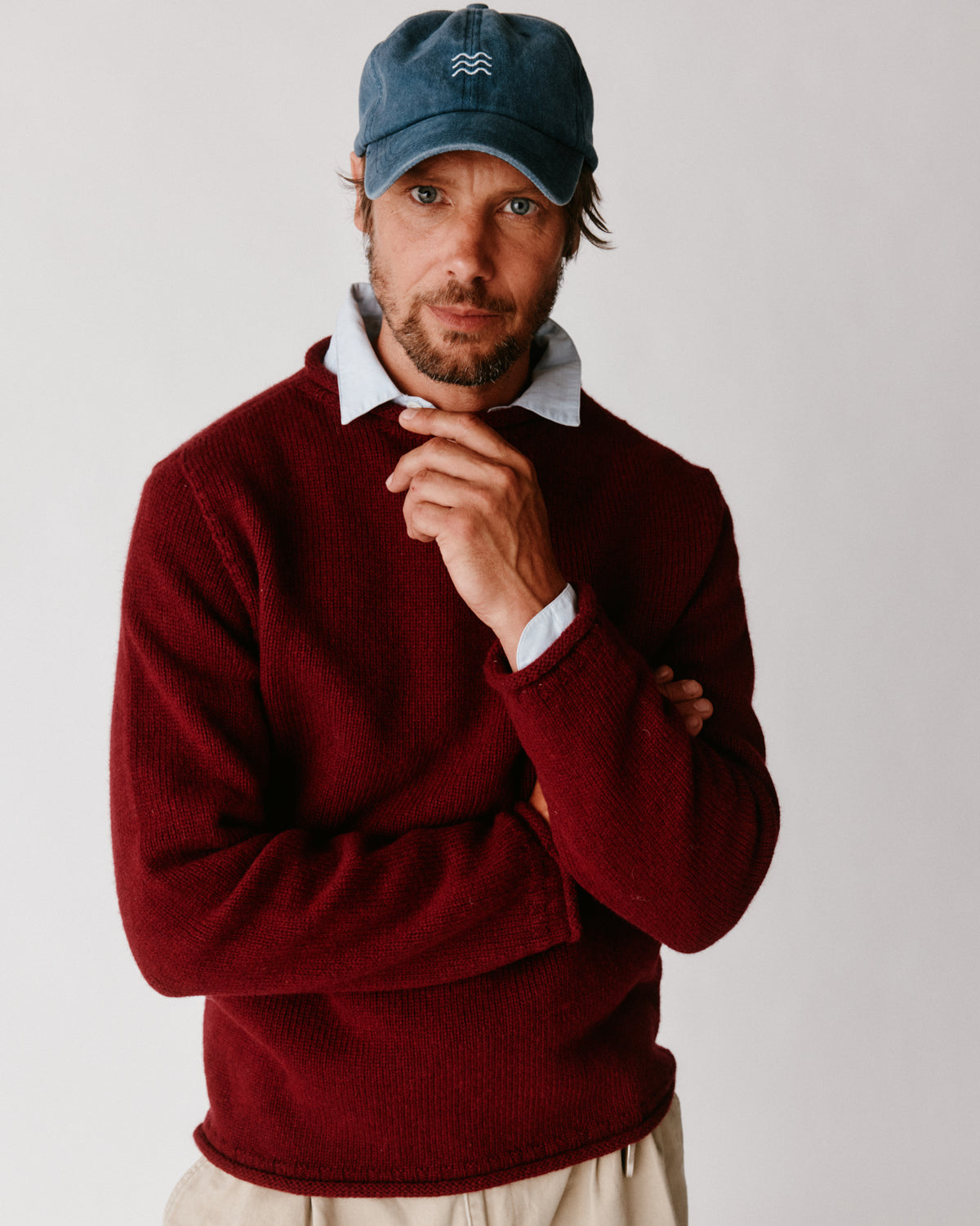 A model wearing a Bosie Blue Mogganer Whaler Rolled Neck Chunky Sweater in colour Claret / Bordeaux Mix.