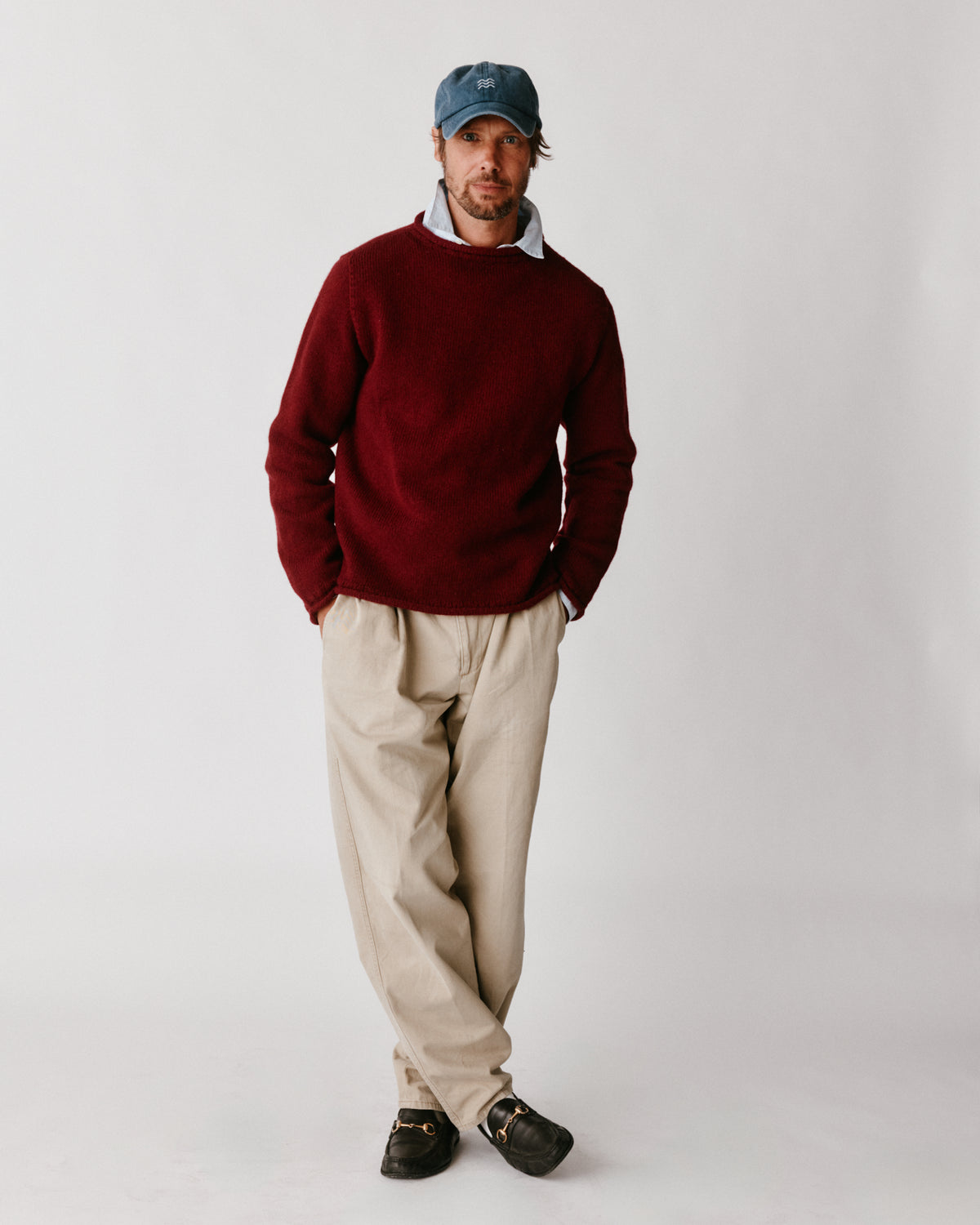 A model wearing a Bosie Blue Mogganer Whaler Rolled Neck Chunky Sweater in colour Claret / Bordeaux Mix.
