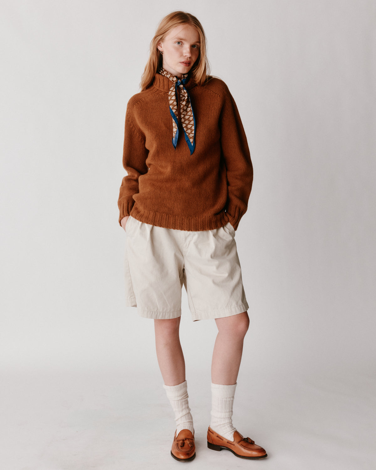 A model wearing a Bosie Blue Mogganer Womens Siren Merino Polo Neck Sweater in colour Vintage Vicuna.
