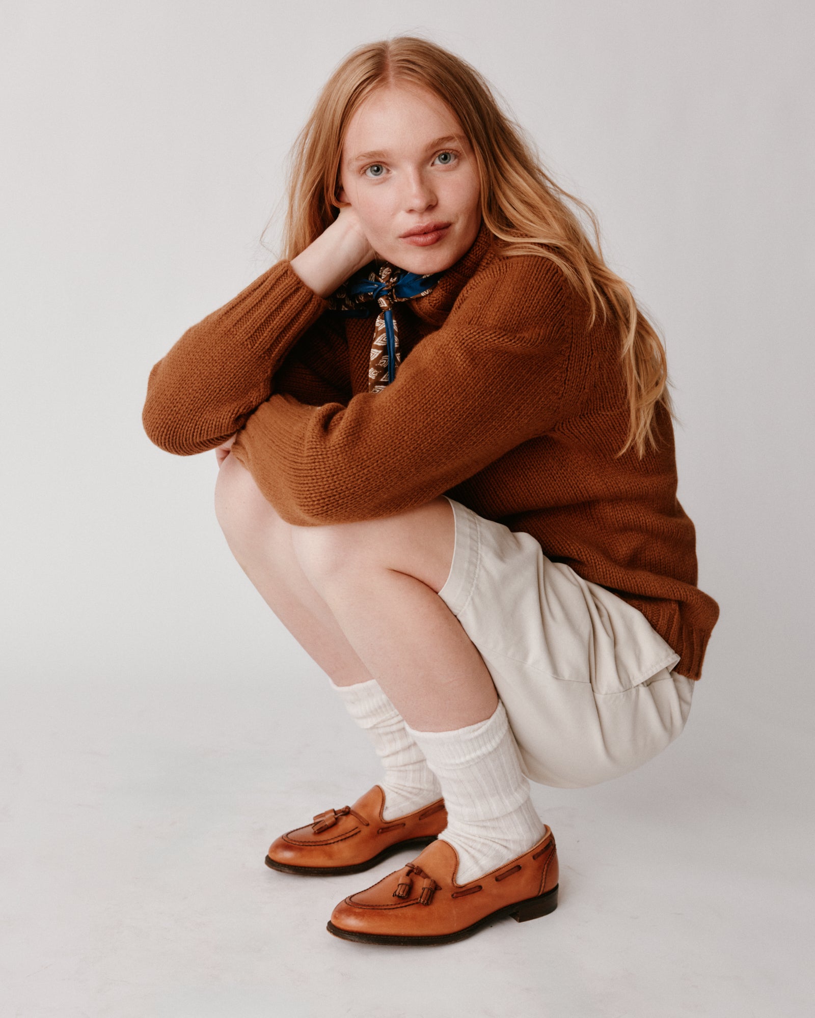 A model wearing a Bosie Blue Mogganer Womens Siren Merino Polo Neck Sweater in colour Vintage Vicuna.