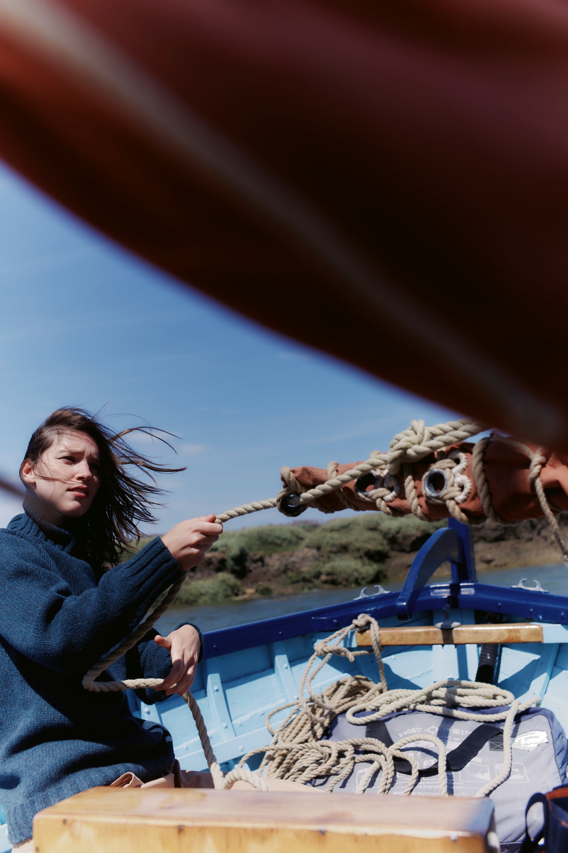 Model wearing a Bosie Knitwear Blue Mogganer Womens Siren Merino Polo Neck Sweater in colour Lugano Dark Teal.