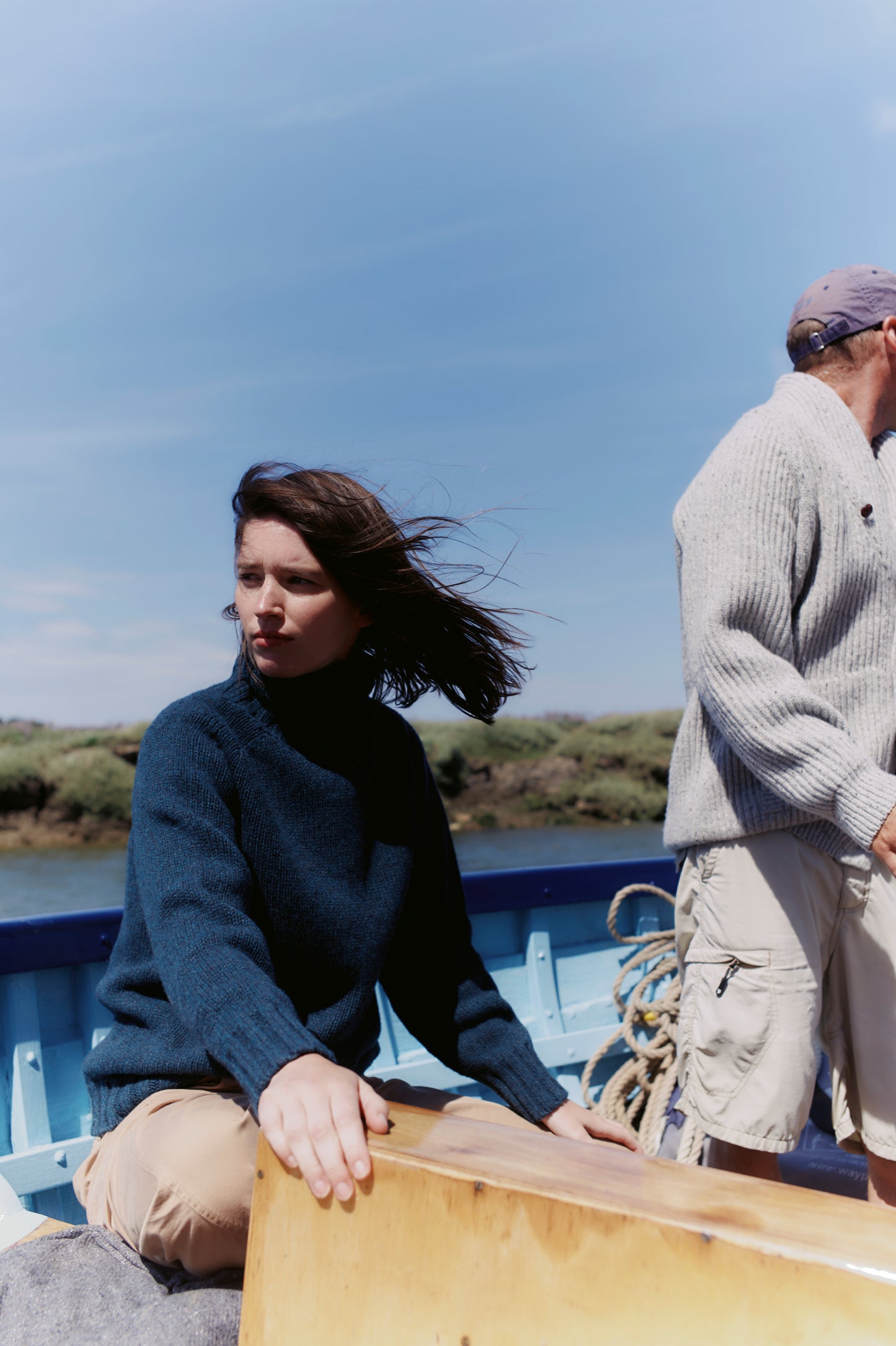 Model wearing a Bosie Knitwear Blue Mogganer Womens Siren Merino Polo Neck Sweater in colour Lugano Dark Teal.