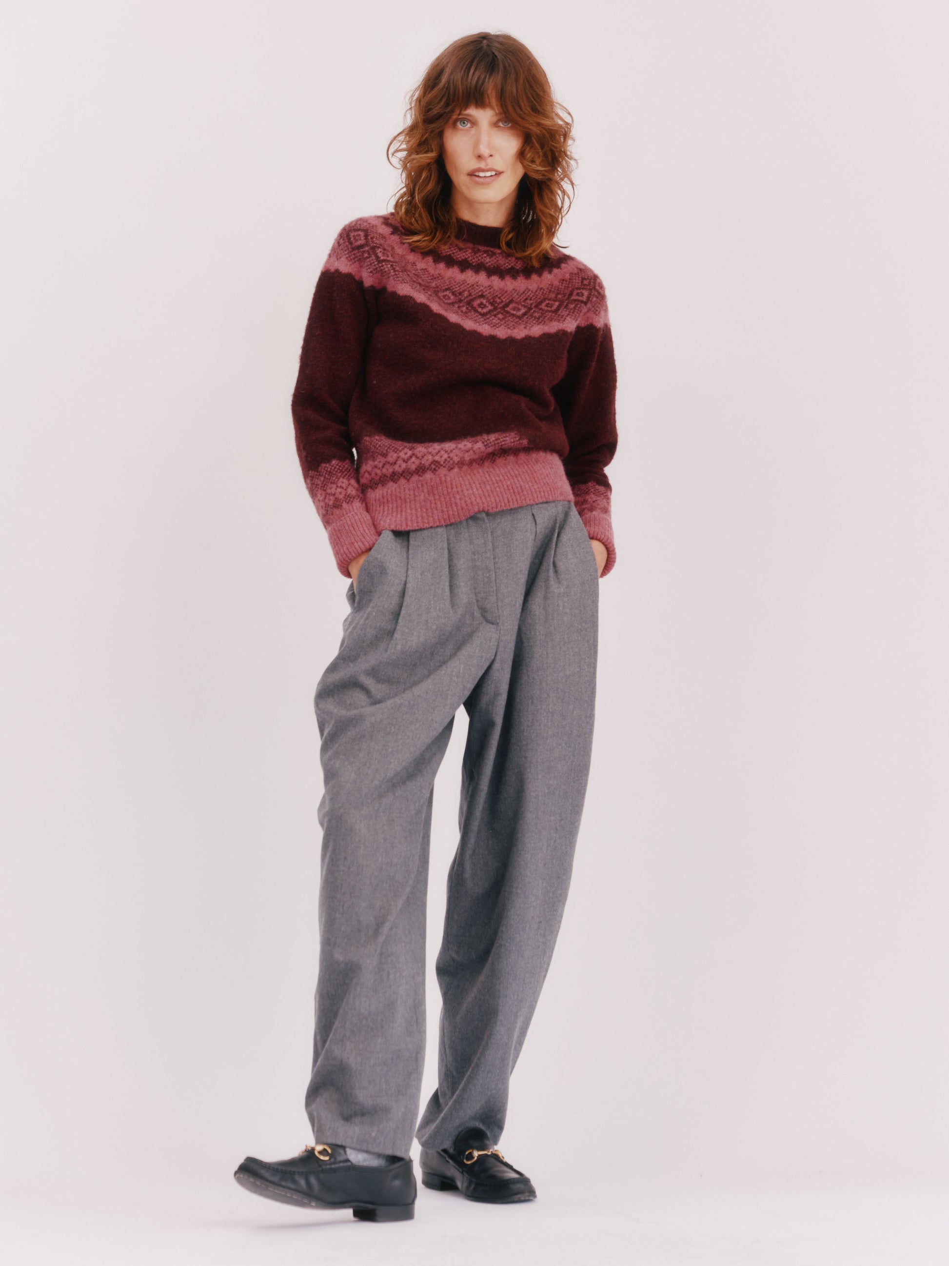 Model wearing a Bosie Knitwear Borealis Yoke Brushed Fair Isle Women's Lambswool Sweater in colour Dark Cranberry.