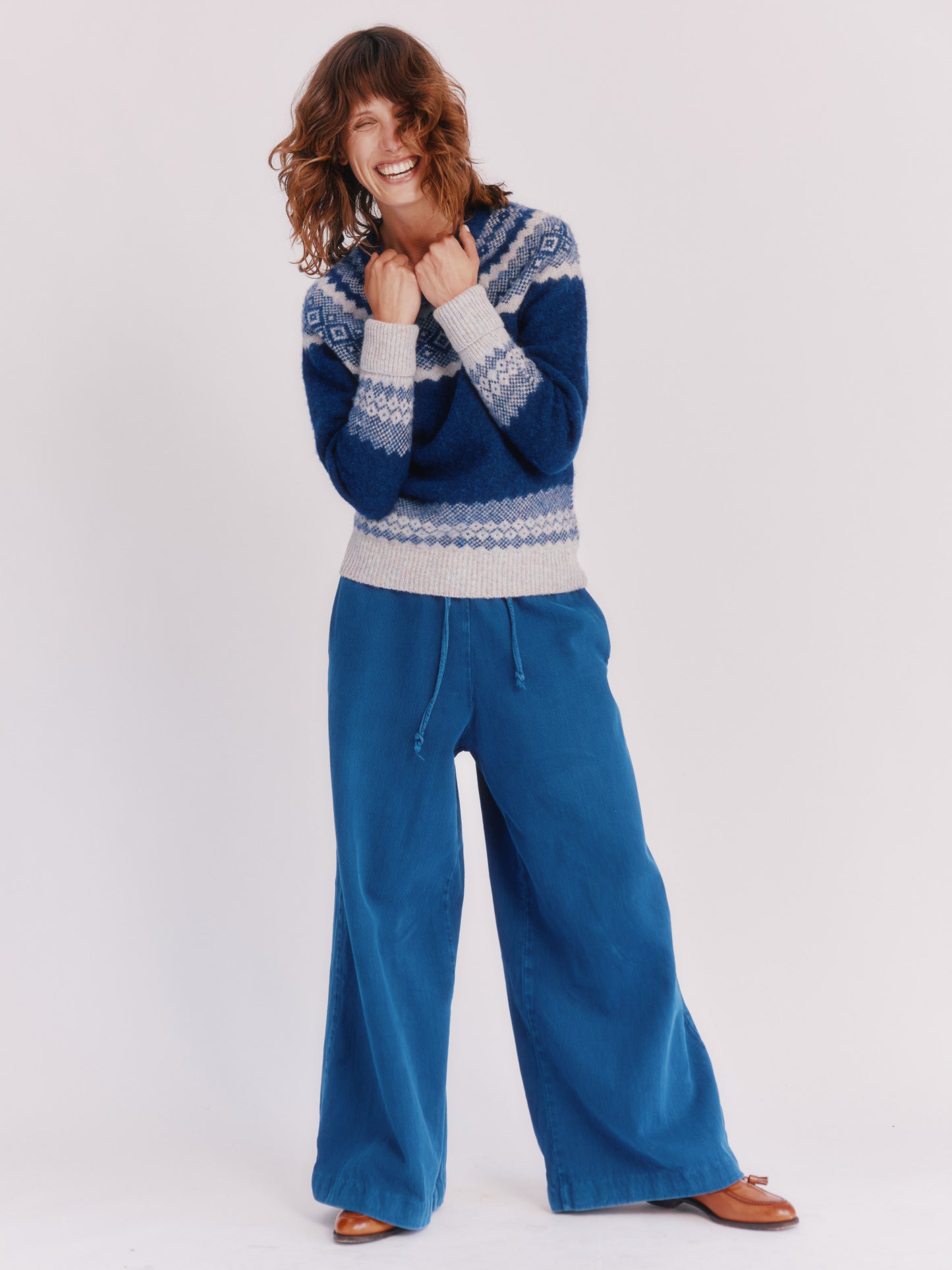 Model wearing a Bosie Knitwear Borealis Yoke Brushed Fair Isle Women's Lambswool Sweater in colour Starnight Blue.
