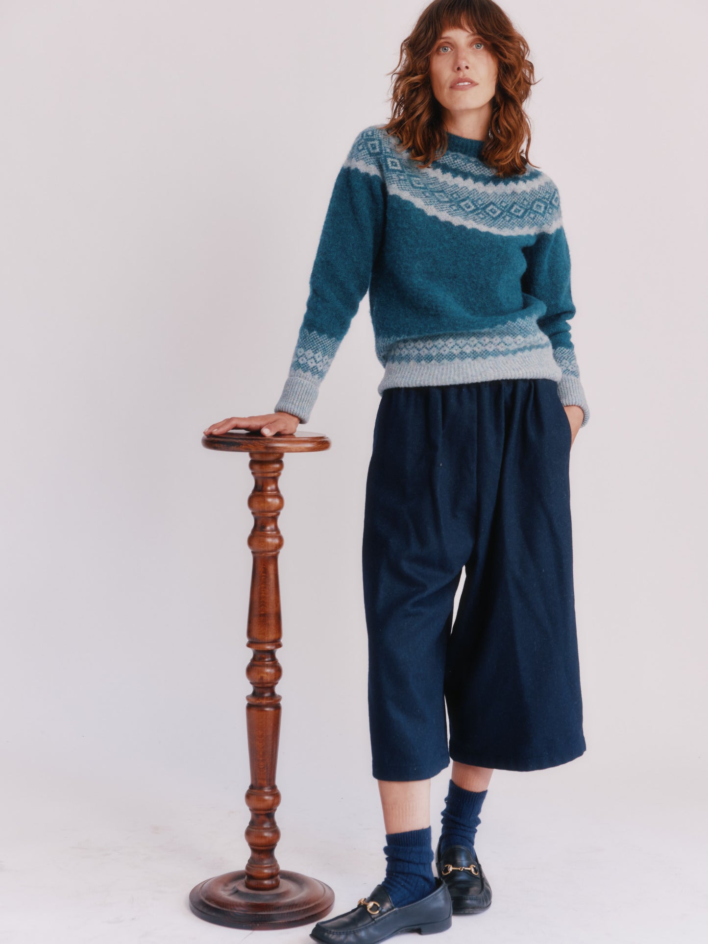 Model wearing Borealis Yoke Brushed Fair Isle Women's Lambswool Sweater in colour Storm Dark Teal.