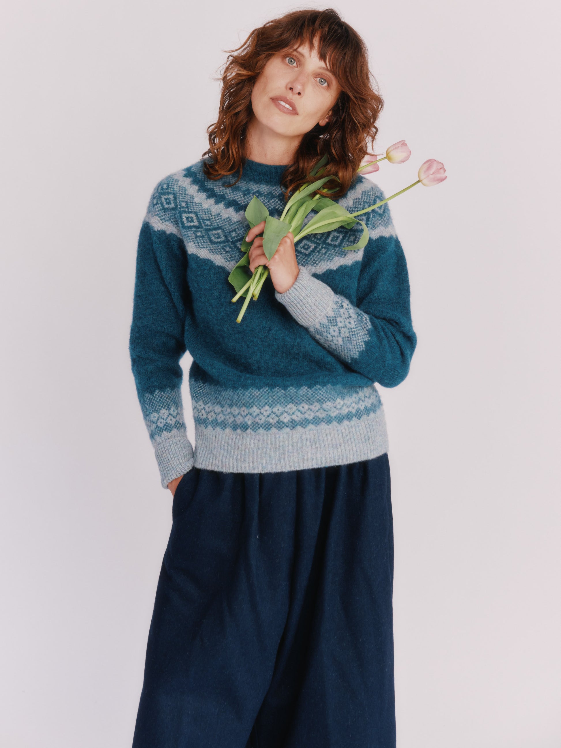 Model wearing Borealis Yoke Brushed Fair Isle Women's Lambswool Sweater in colour Storm Dark Teal.