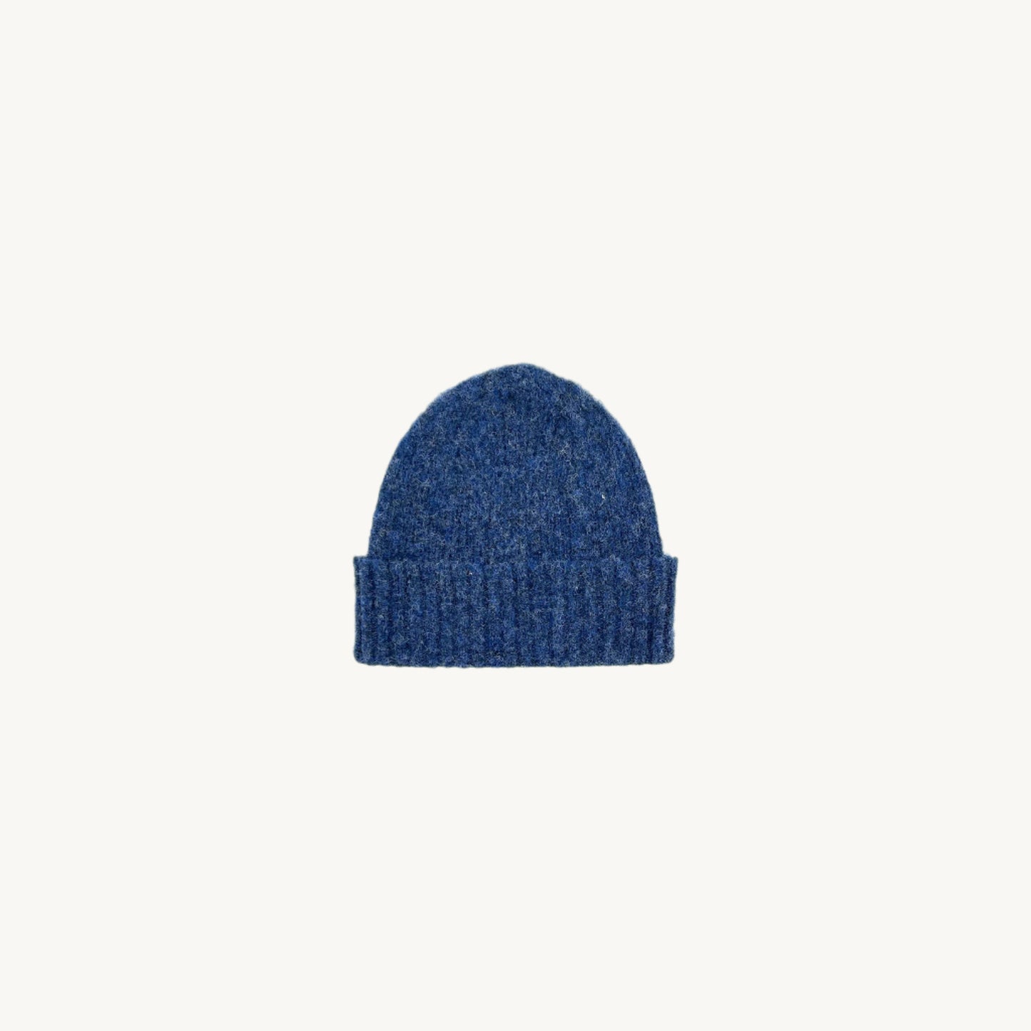 A flatbed photograph of a Bosie Brushed Shetland Wool Beanie Hat in colour Denim Blue
