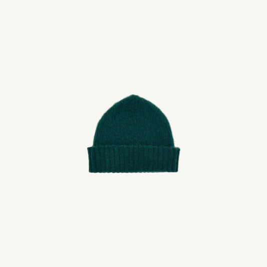 Flat bed photograph of Bosie Brushed Shetland Wool Beanie Hat in the colour Forest Green