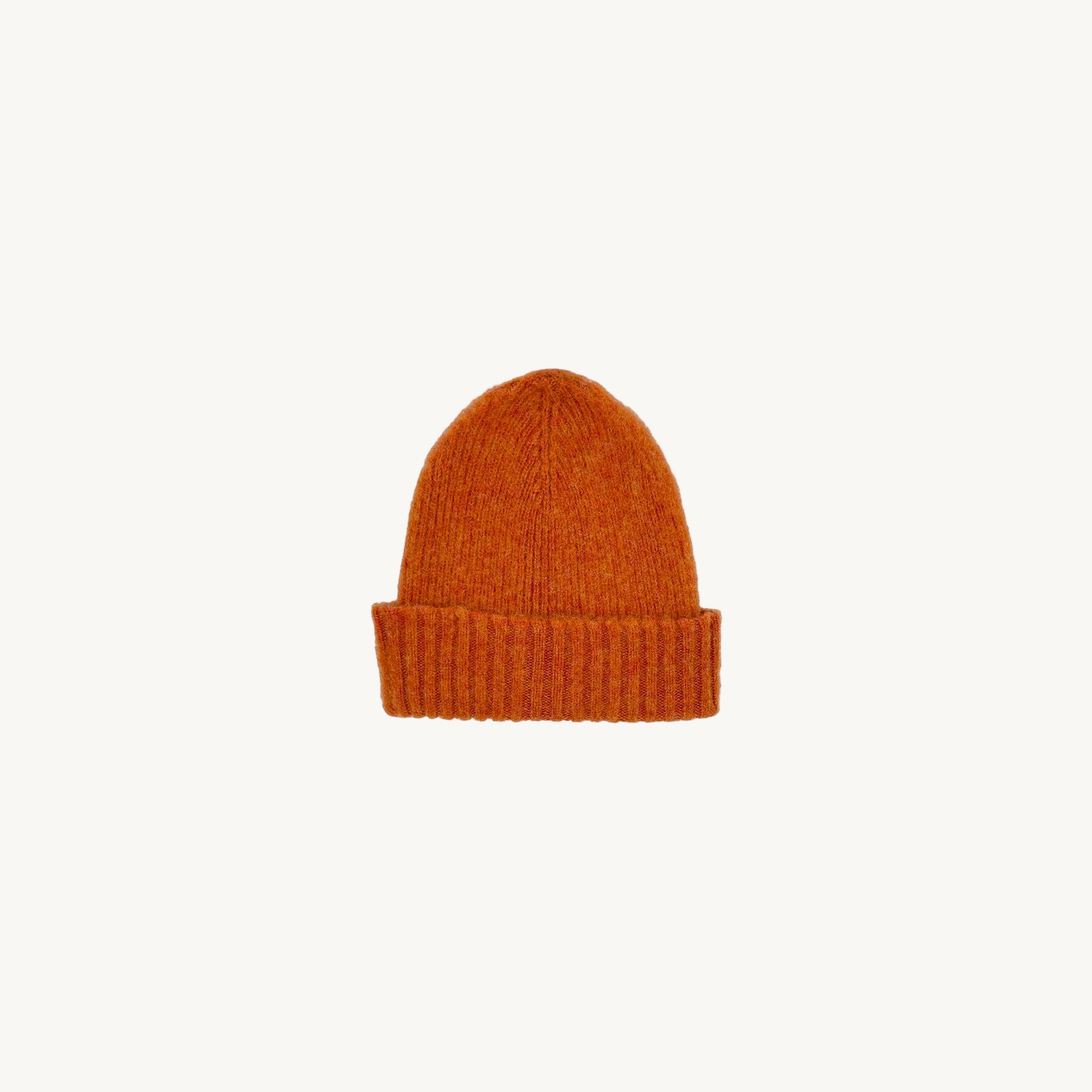 Flat bed photograph of Bosie Brushed Shetland Wool Beanie Hat in the colour Jaffa Orange.