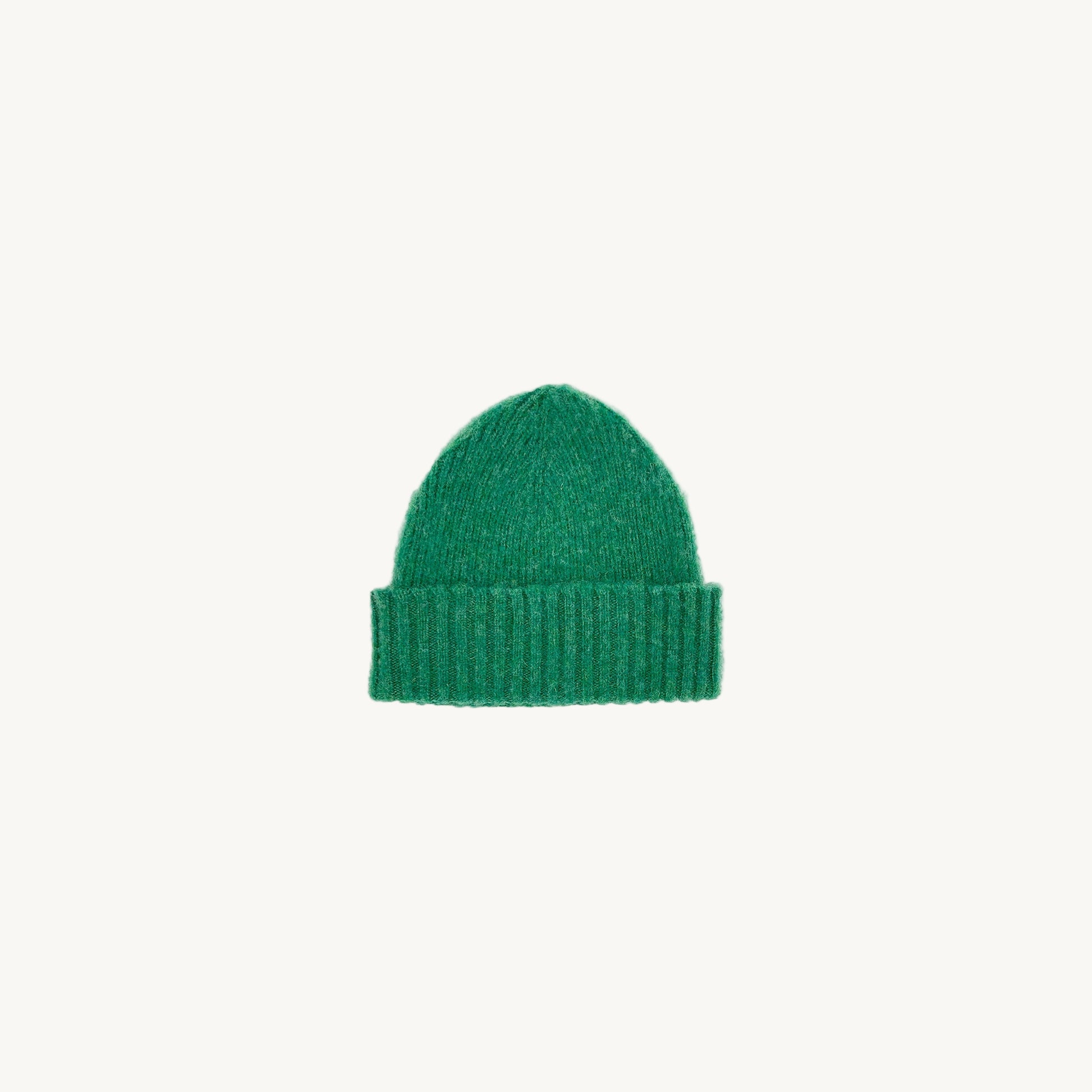 Flat bed photograph of Bosie Brushed Shetland Wool Beanie Hat in the colour Kelly Green.