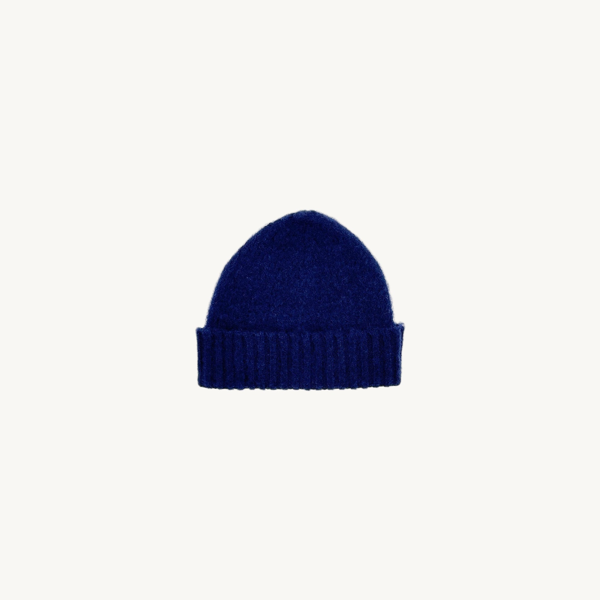 Flat bed photograph of Bosie Brushed Shetland Wool Beanie Hat in the colour Navy.
