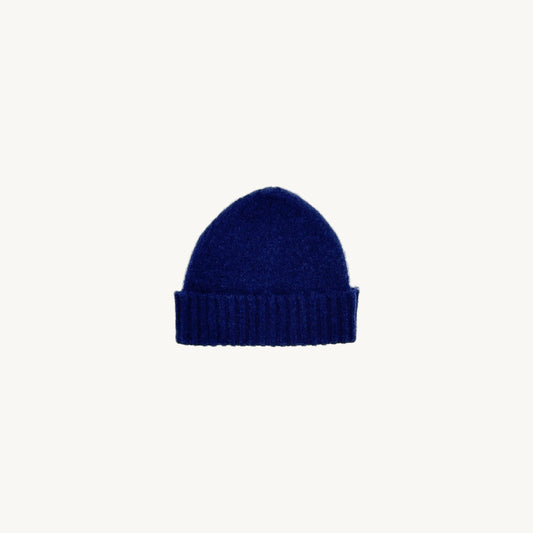 Flat bed photograph of Bosie Brushed Shetland Wool Beanie Hat in the colour Navy.