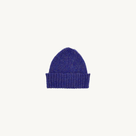 Flat bed photograph of Bosie Brushed Shetland Wool Beanie Hat in the colour Royal Violet Purple.