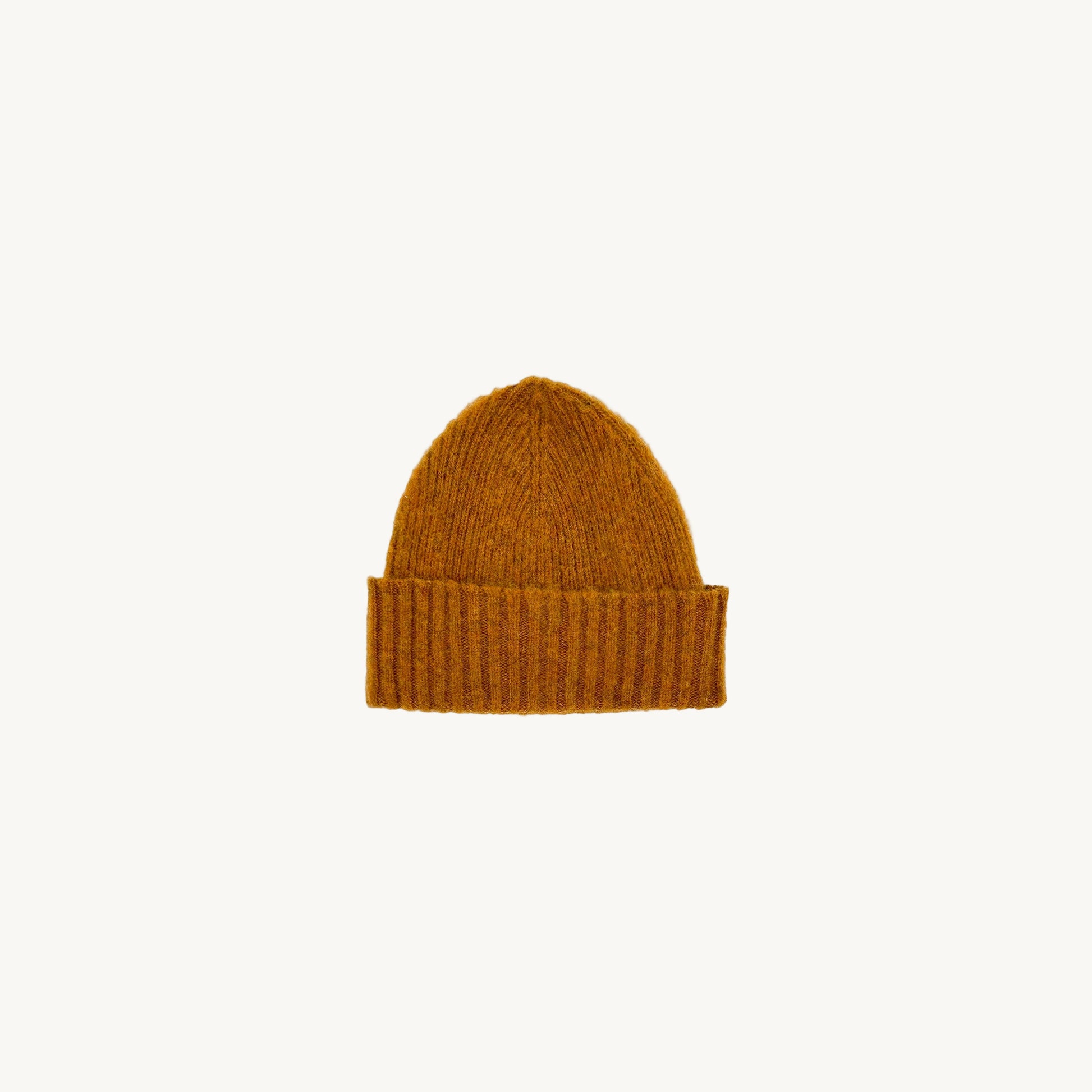 Flat bed photograph of Bosie Brushed Shetland Wool Beanie Hat in the colour Vintage Orange.
