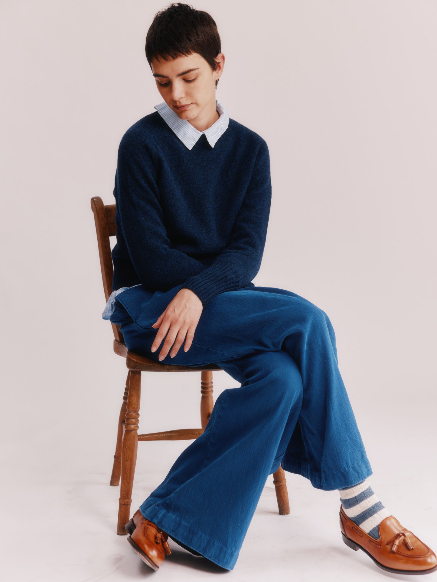 Model wearing a Bosie Knitwear  Geelong 2ply Crew Neck Womens Jumper in colour Cosmos Navy.