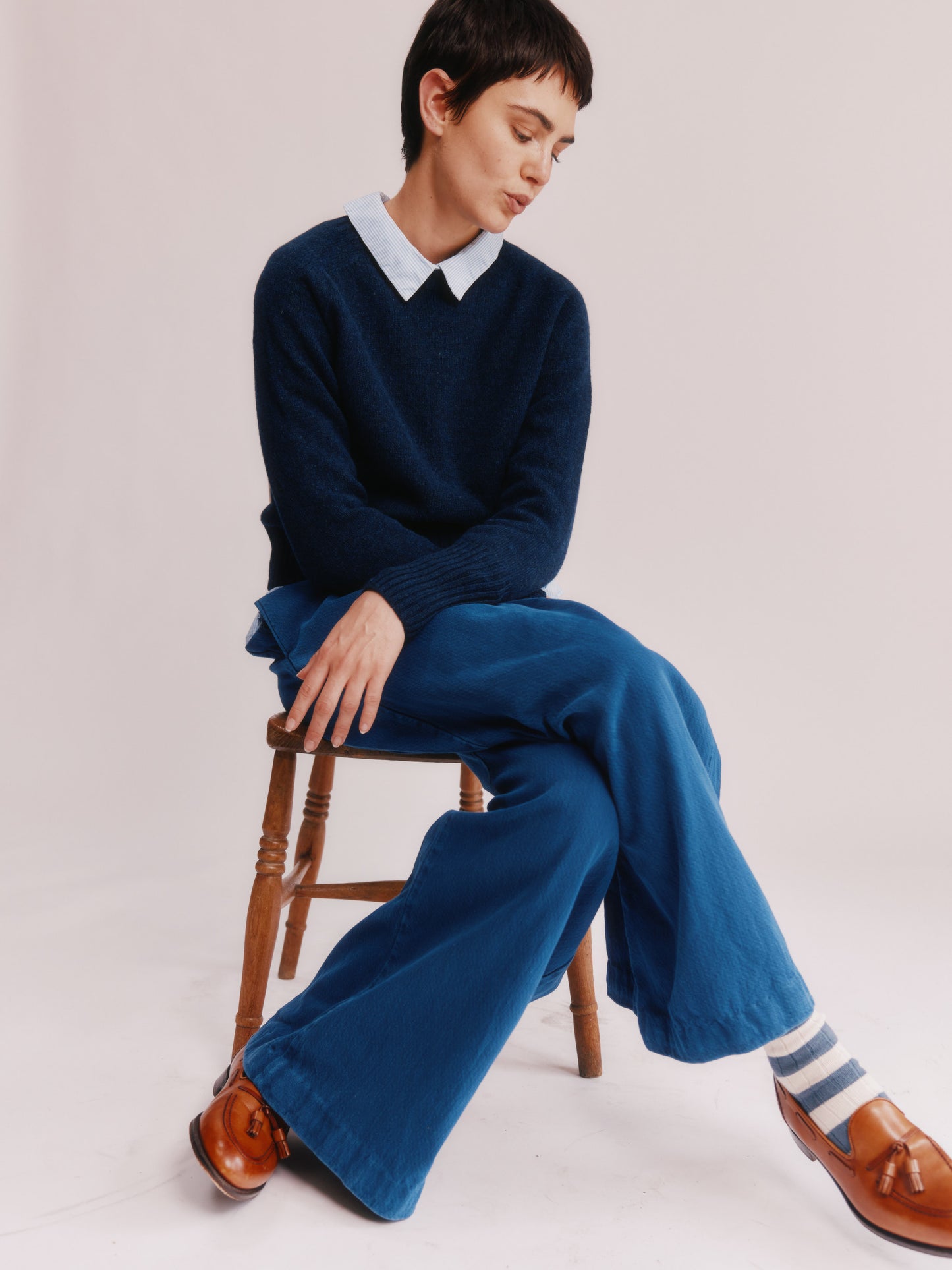 Model wearing a Bosie Knitwear  Geelong 2ply Crew Neck Womens Jumper in colour Cosmos Navy.