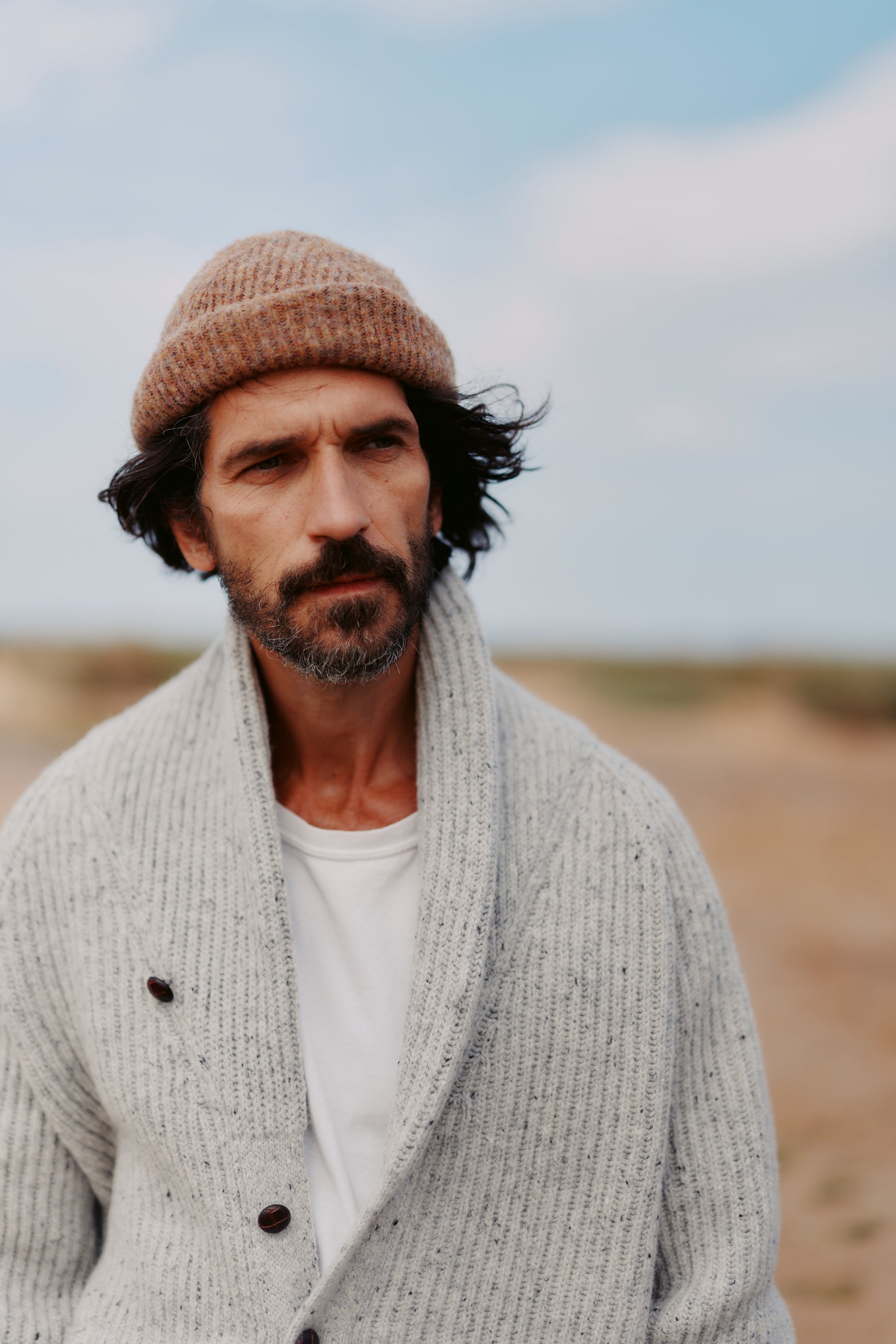 Man wearing a Bosie Blue Mogganer Harbourmaster Cardigan outdoors with a blurred background