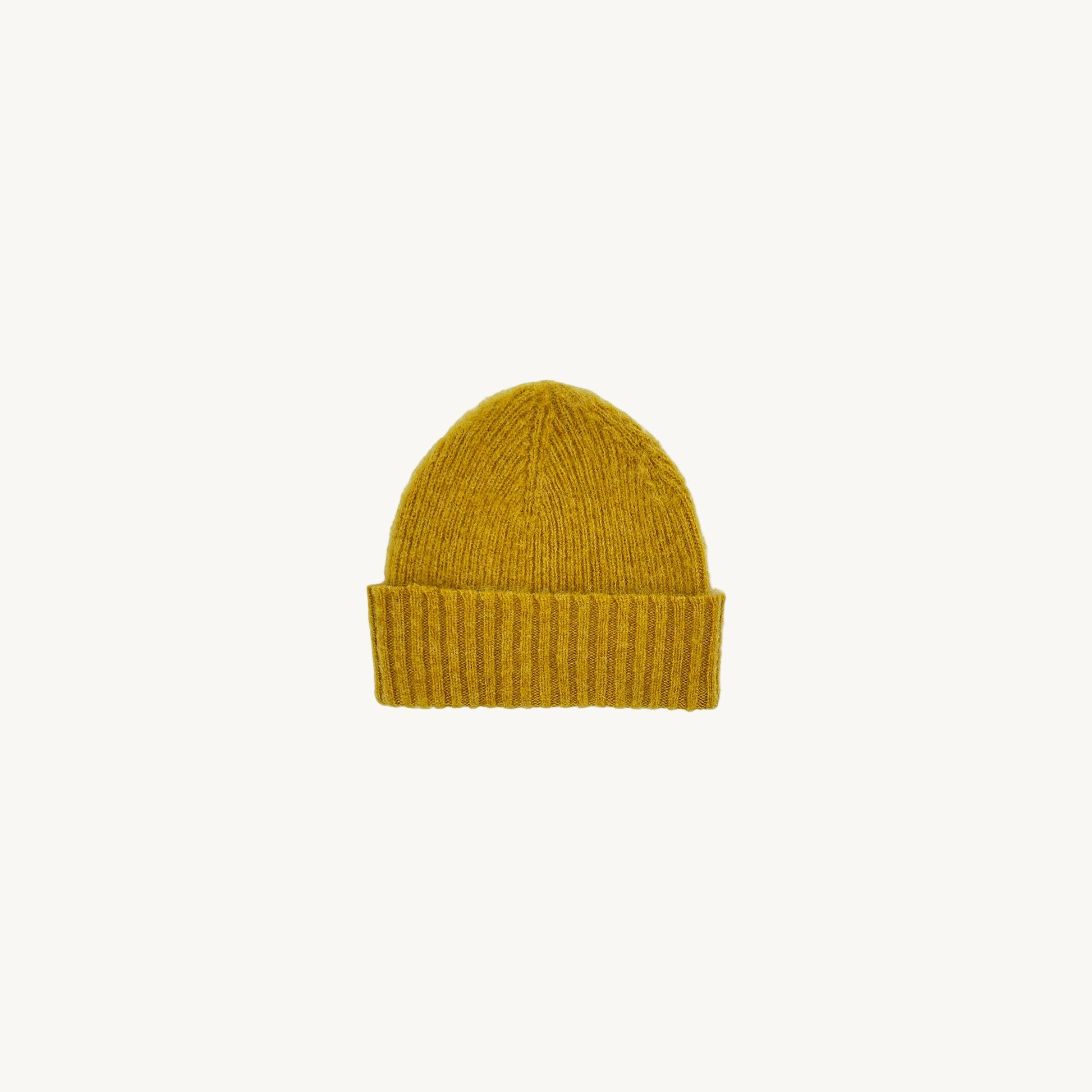 Flatbed photograph of Bosie Brushed Shetland Wool Beanie Hat in colour Nugget Yellow. 
