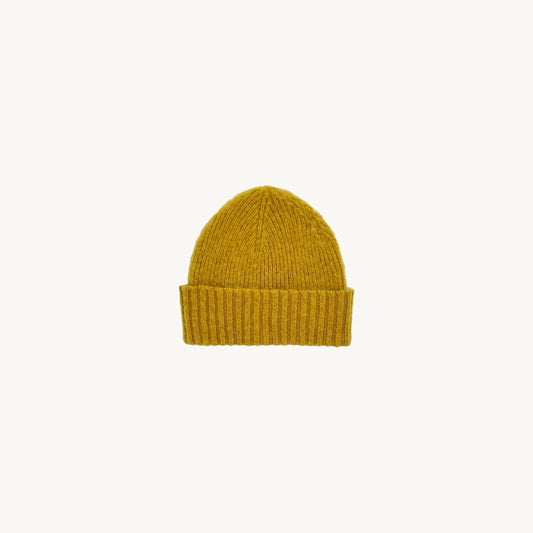 Flatbed photograph of Bosie Brushed Shetland Wool Beanie Hat in colour Nugget Yellow. 