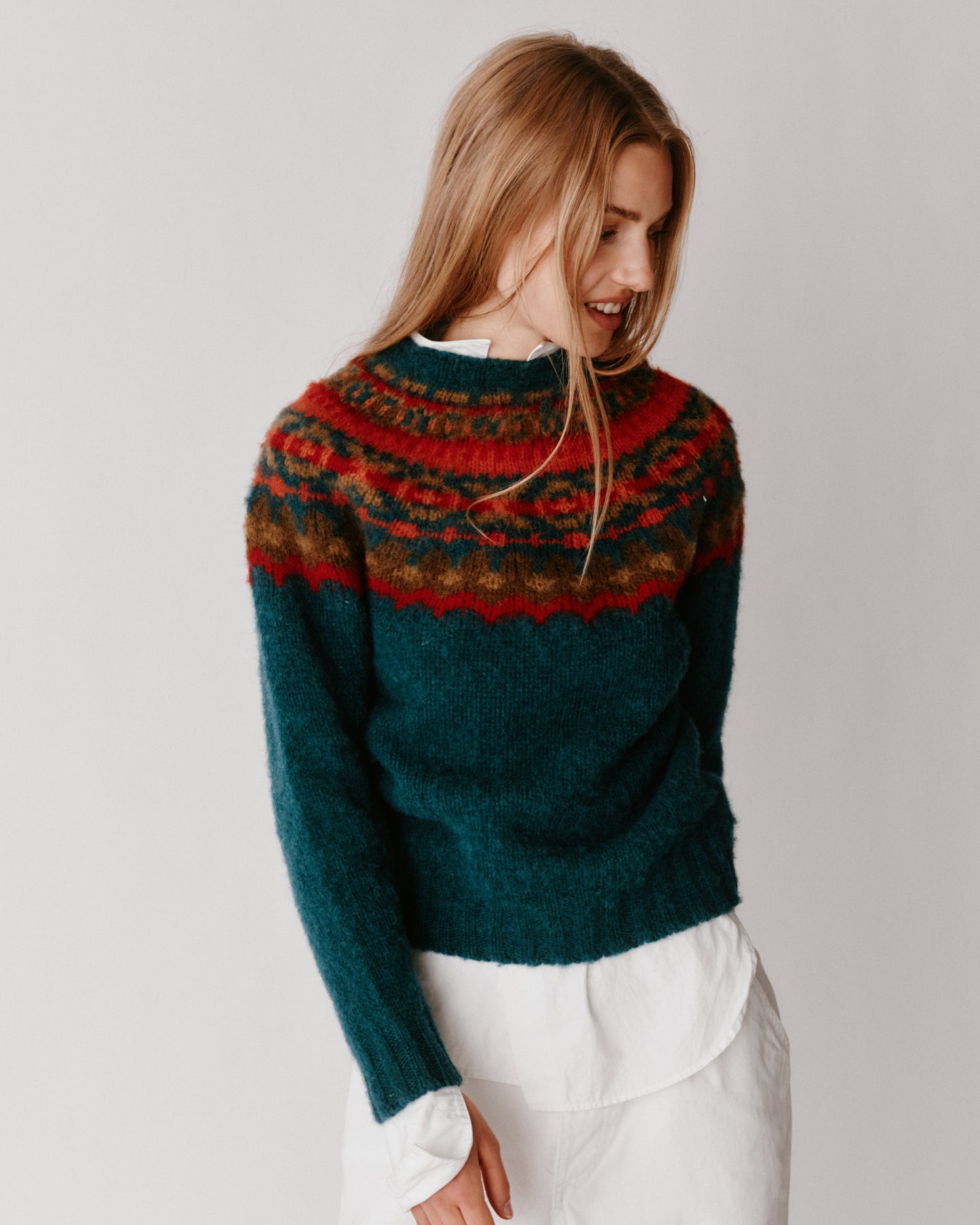 A model wearing a Bosie Braemar Yoke Brushed Fair Isle Women's Lambswool Sweater in colour Tempest.