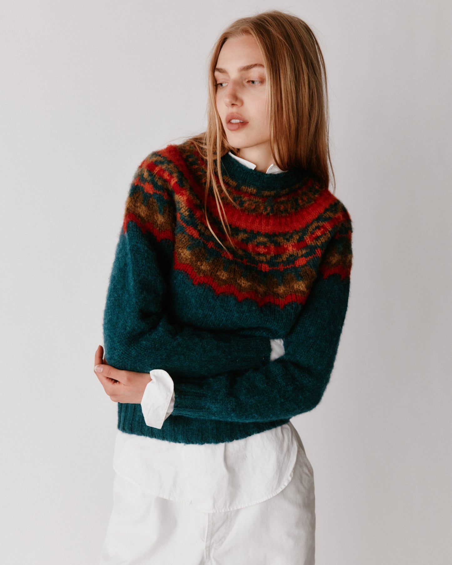 A model wearing a Bosie Braemar Yoke Brushed Fair Isle Women's Lambswool Sweater in colour Tempest.