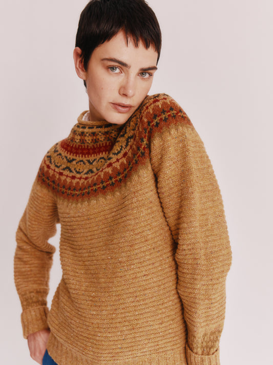 Model wearing a Bosie Knitwear Cottage Fair Isle Glenugie Nep Women's Sweater in colour Barra Gold.