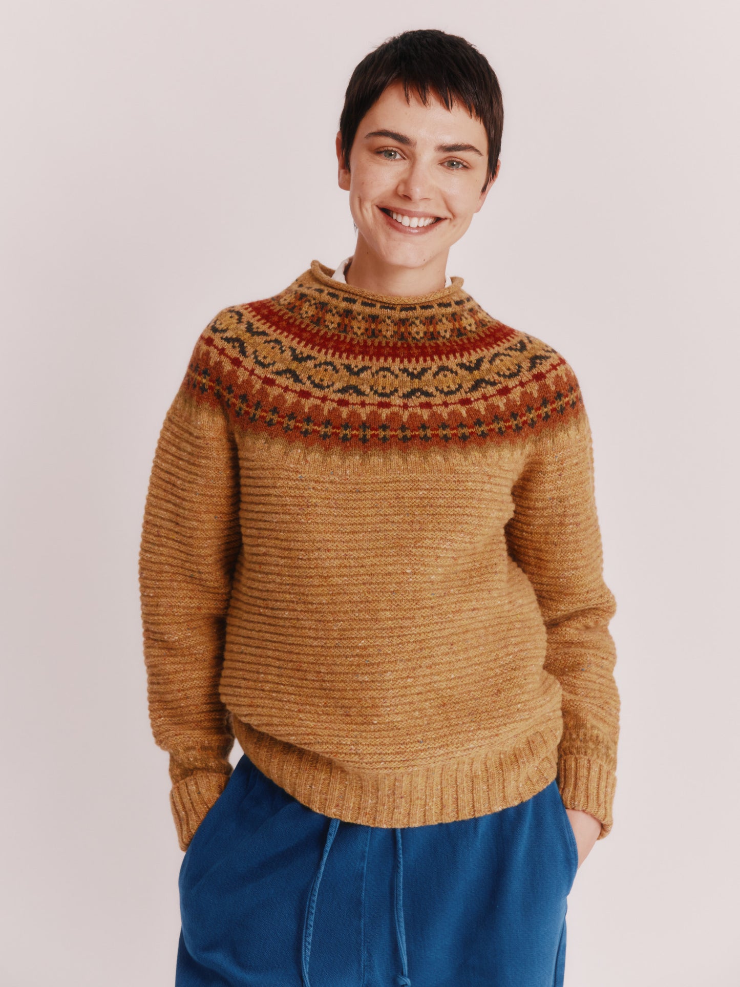 Model wearing a Bosie Knitwear Cottage Fair Isle Glenugie Nep Women's Sweater in colour Barra Gold.