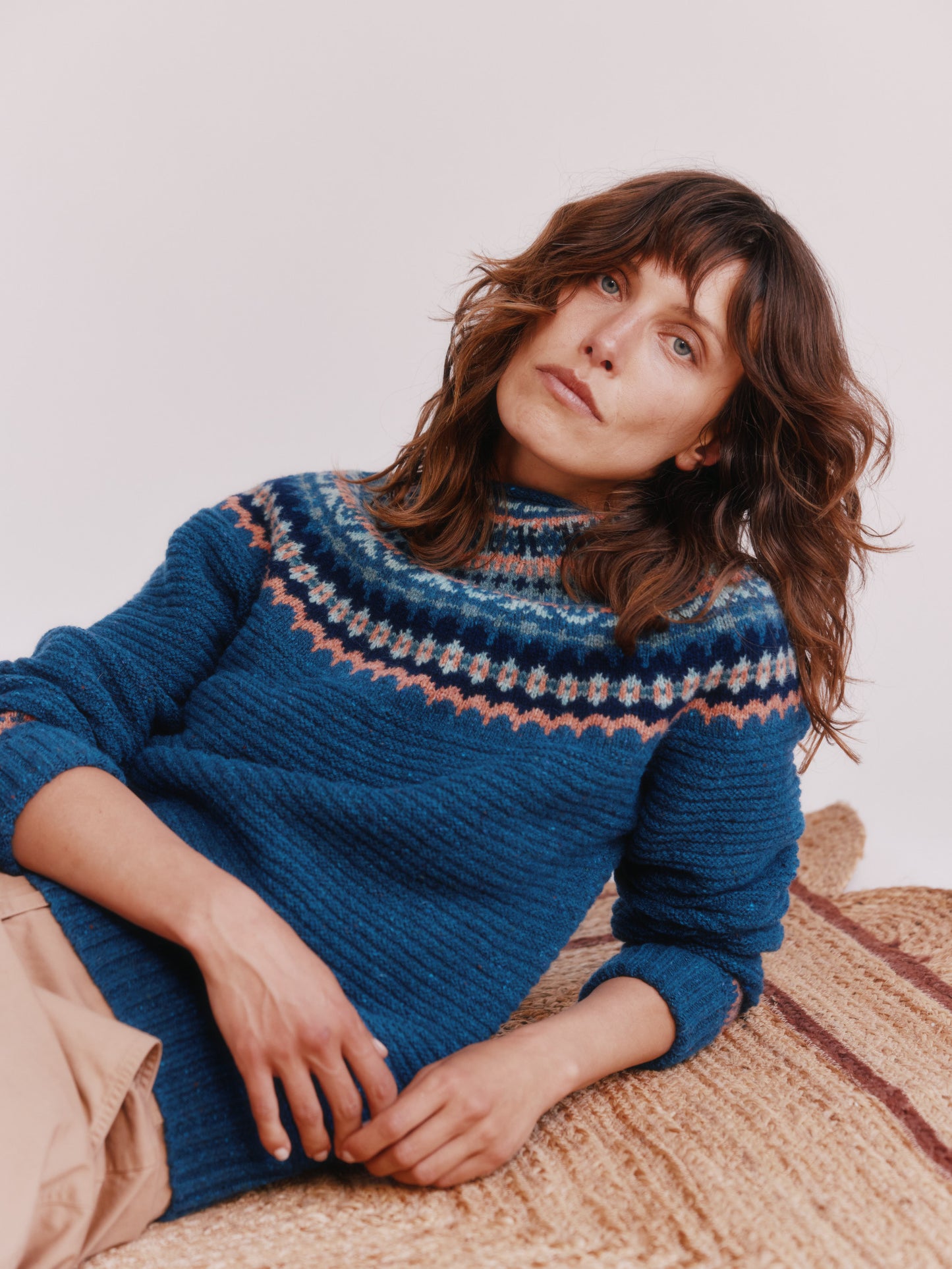 Model wearing a Bosie Knitwear Cottage Fair Isle Glenugie Nep Women's Sweater in colour Soay Blue.