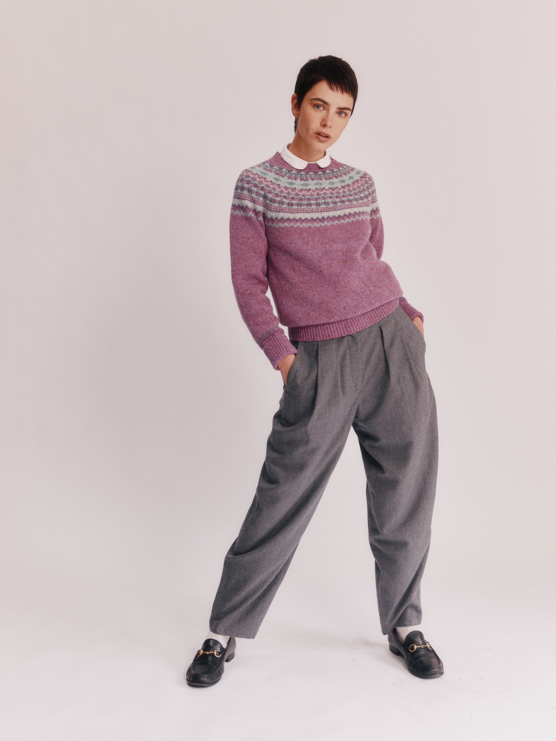 Model wearing a Bosie Knitwear Crofter Yoke Fair Isle Glenugie Nep Women's Sweater in colour Shuna Purple.