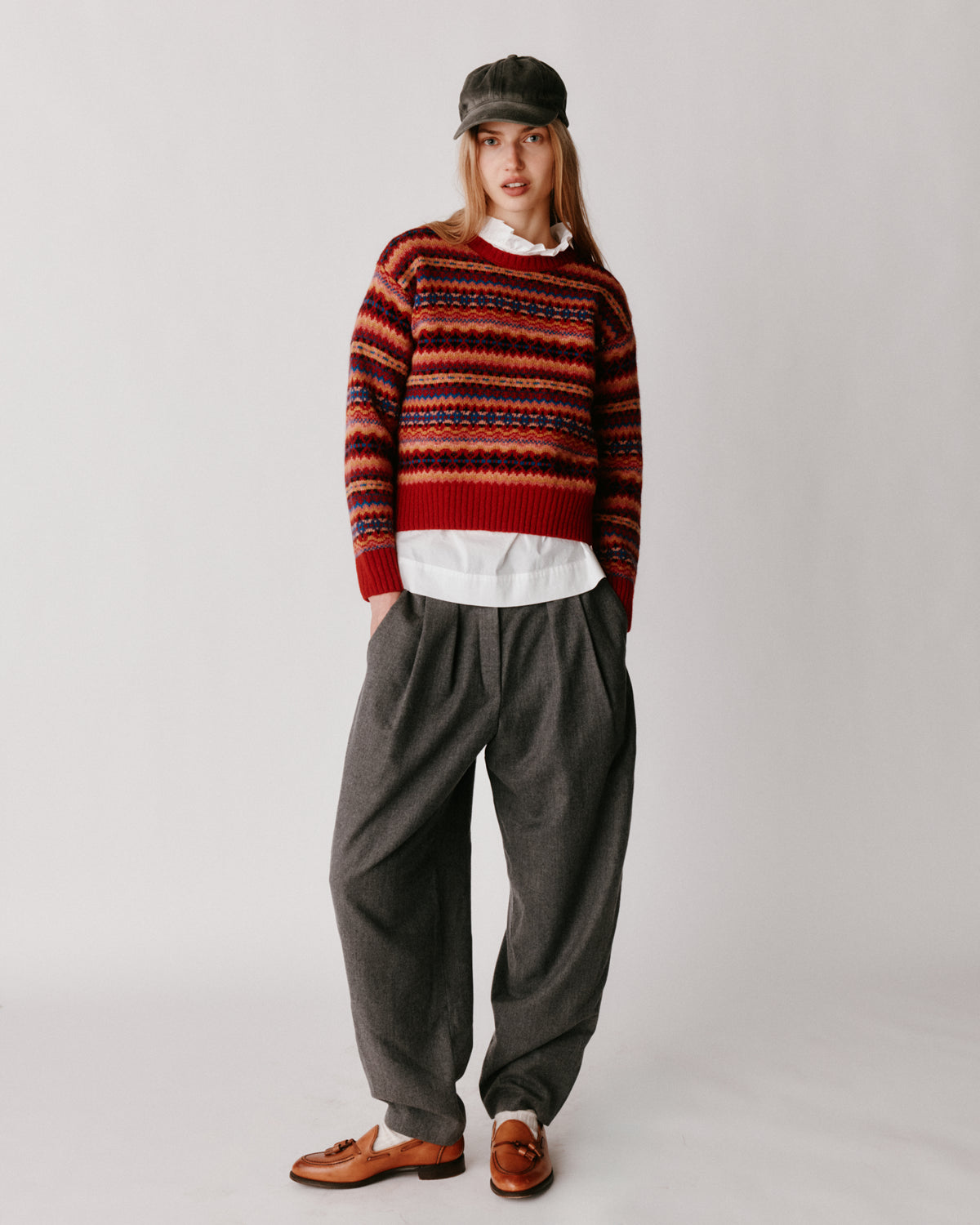 A model wearing a Bosie Cropped Allover Fair Isle Women's Sweater in colour French Red.