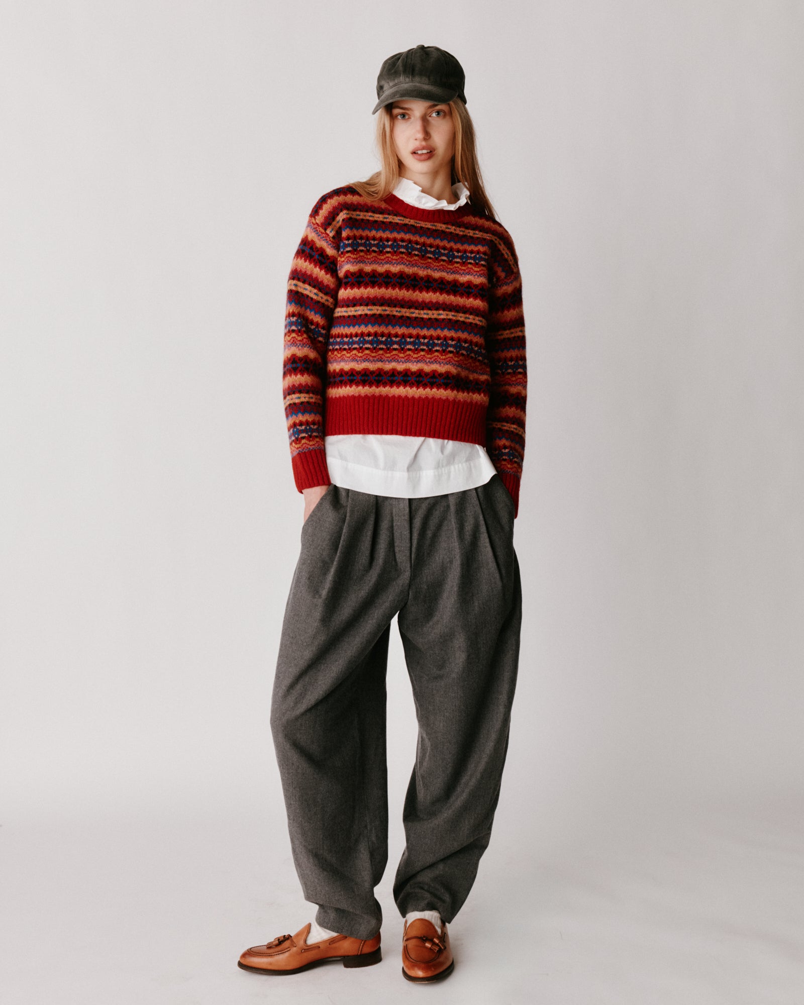 A model wearing a Bosie Cropped Allover Fair Isle Women's Sweater in colour French Red.