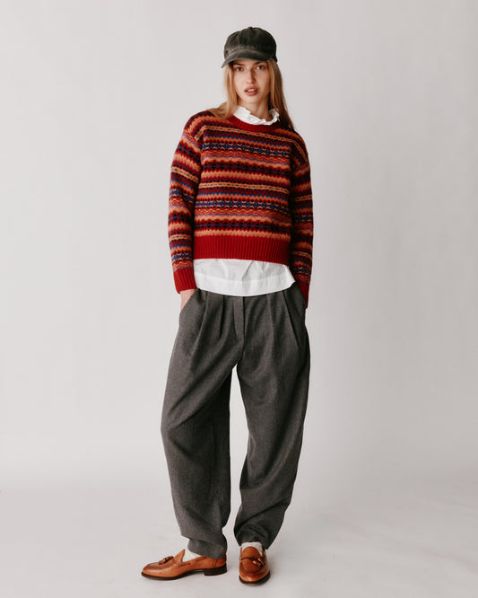 A model wearing a Bosie Cropped Allover Fair Isle Women's Sweater in colour French Red.