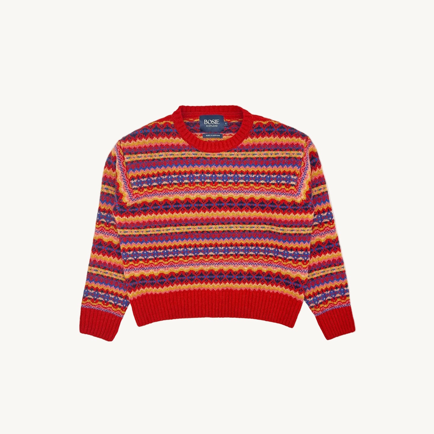 A flatbed photograph of a Bosie Cropped Allover Fair Isle Women's Sweater in colour Cardinal / French Red.