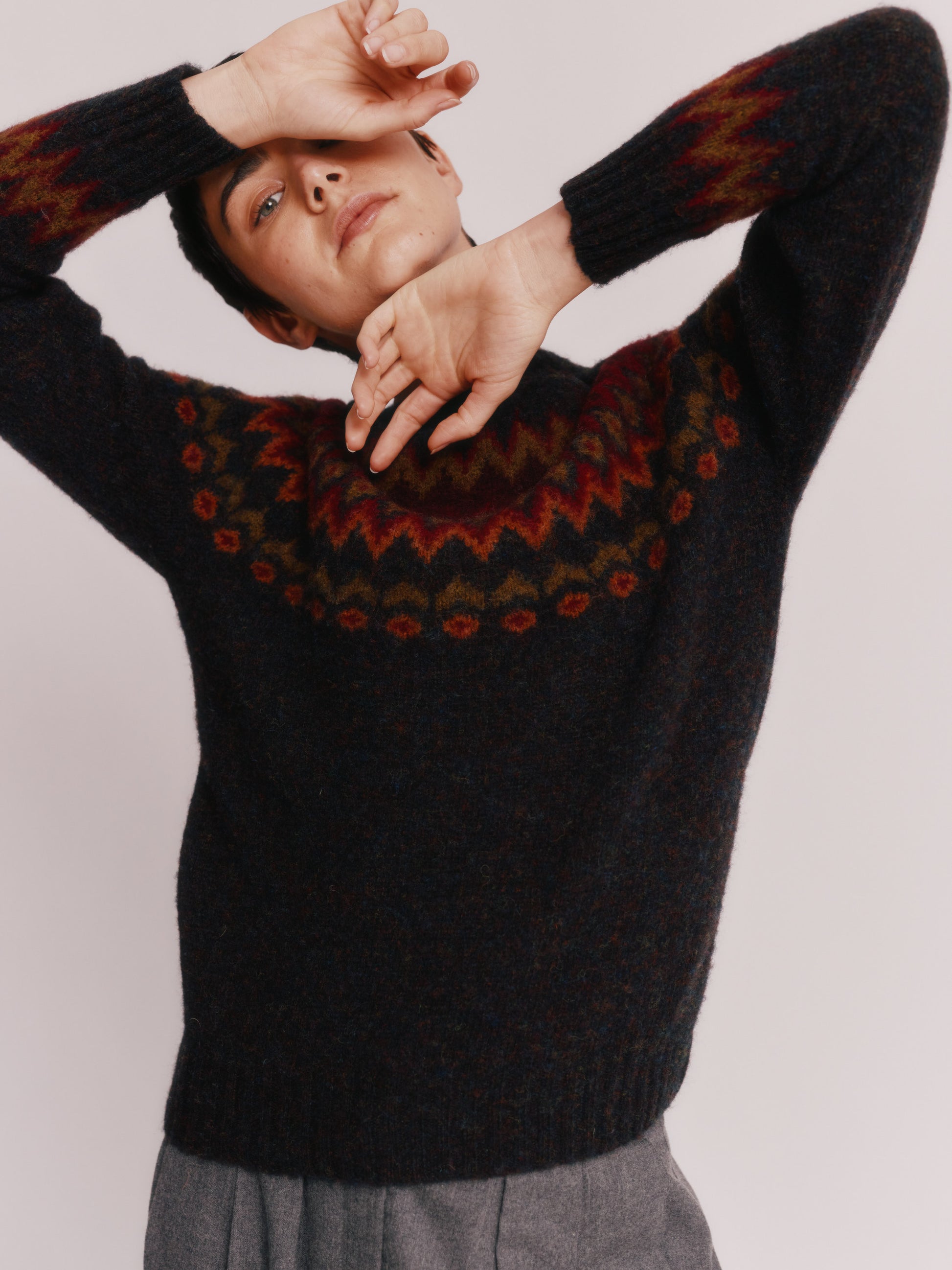Model wearing a Bosie Knitwear Fjord Yoke Brushed Fair Isle Women's Lambswool Sweater in colour Midnight Black.