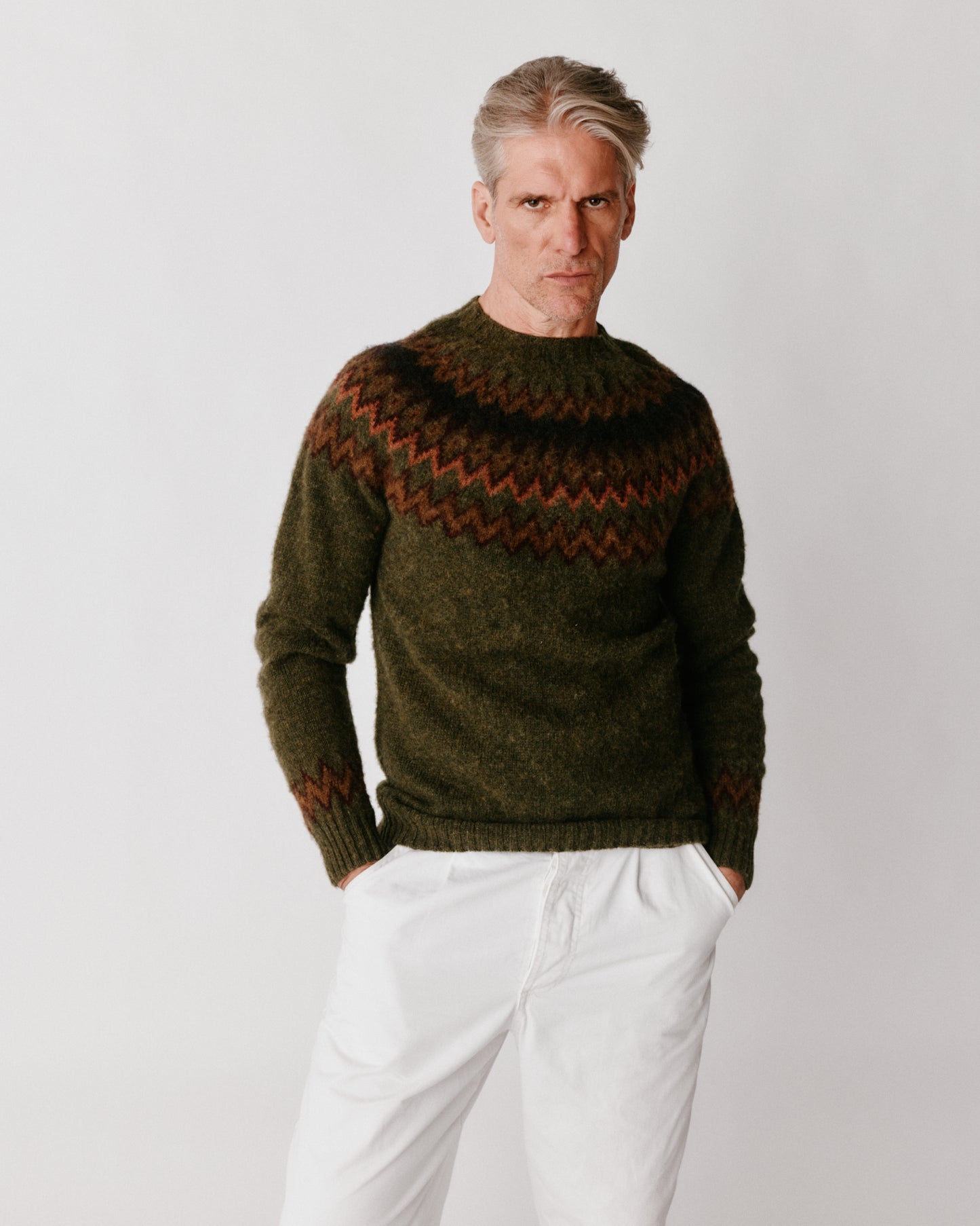 A model wearing a Bosie Glacier Yoke  Brushed Fair Isle Men's Sweater in colour Scots Pine / Pineshadow.