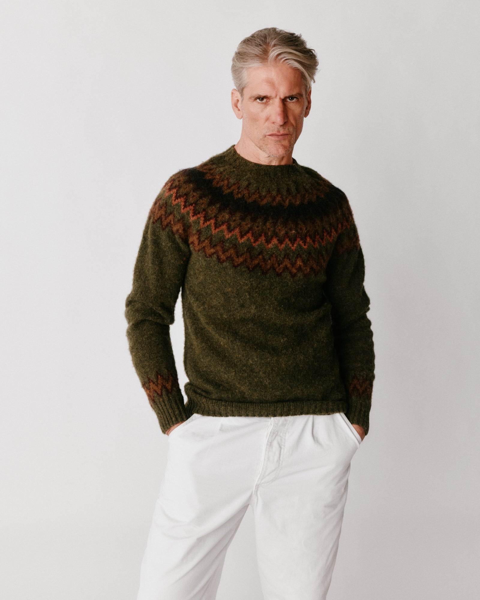 A model wearing a Bosie Glacier Yoke  Brushed Fair Isle Men's Sweater in colour Scots Pine / Pineshadow.