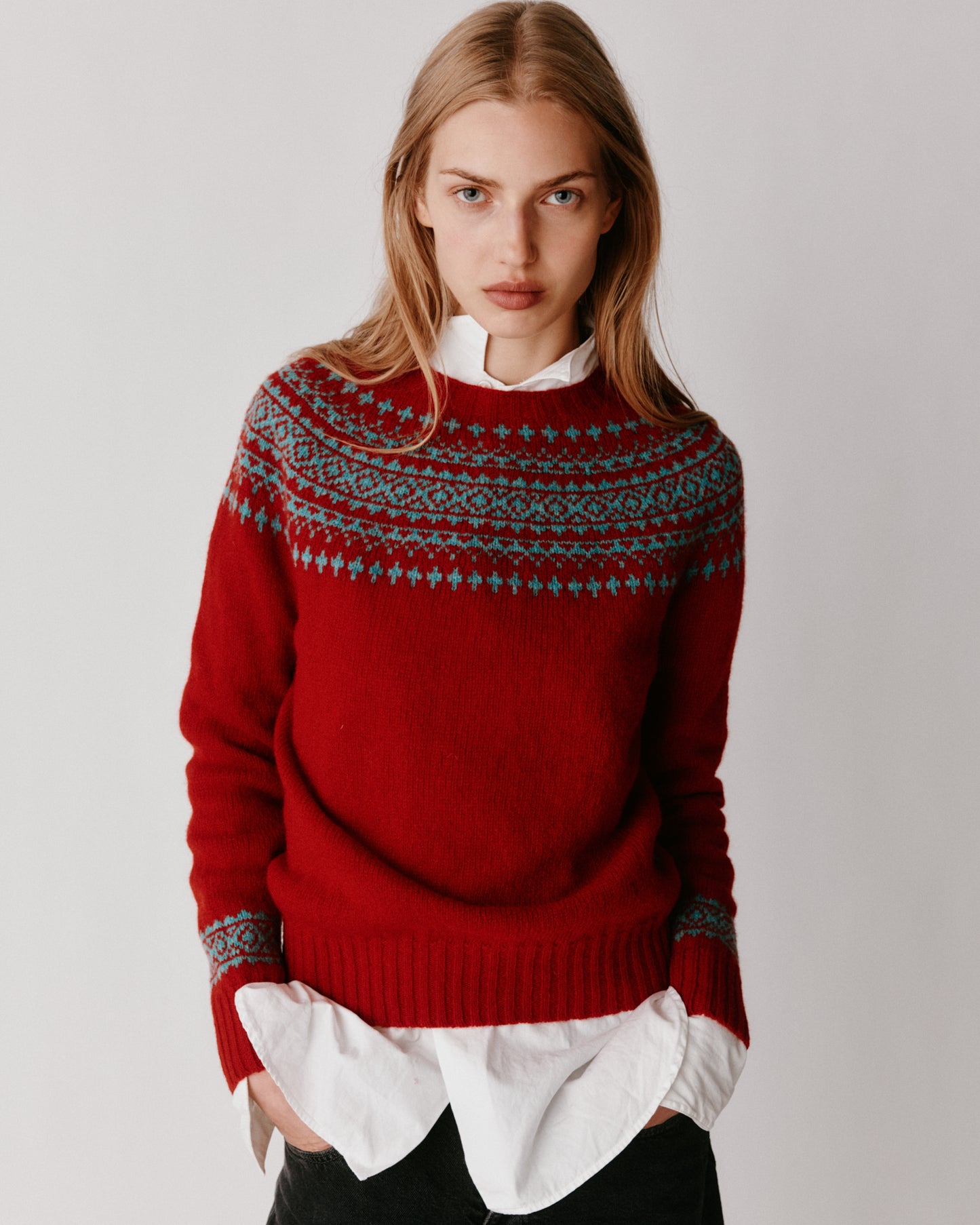 A model wearing a Bosie Hara Yoke Fair Isle Women's Sweater in colour Cardinal.