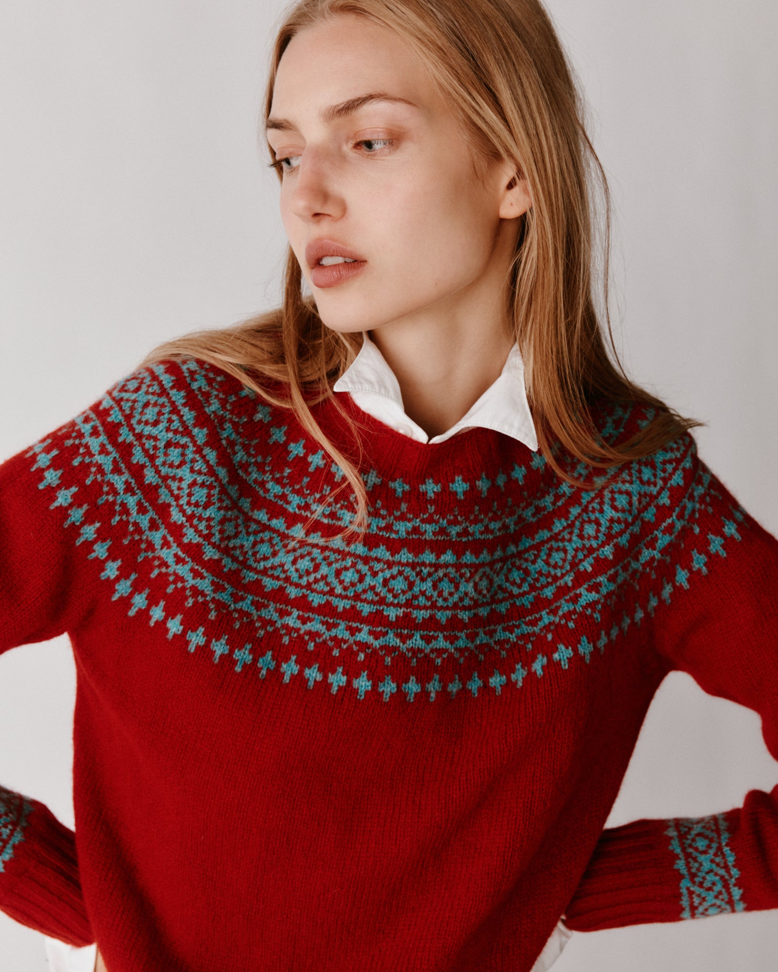 A model wearing a Bosie Hara Yoke Fair Isle Women's Sweater in colour Cardinal.