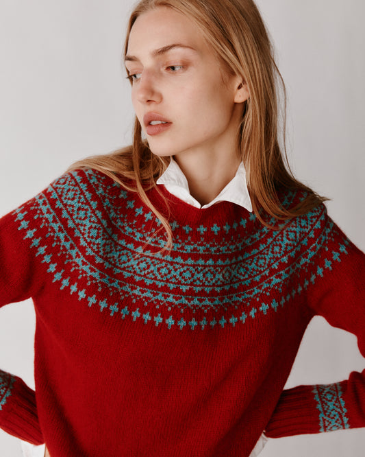 A model wearing a Bosie Hara Yoke Fair Isle Women's Sweater in colour Cardinal.