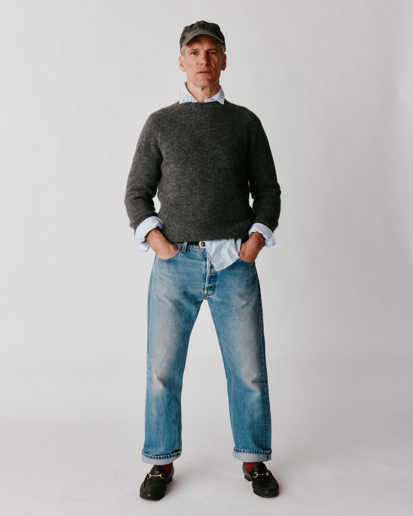 A model wearing a Bosie Harley of Scotland Mens Seamless Saddle Shoulder Shetland Sweater in colour Basalt / Oxford Grey.
