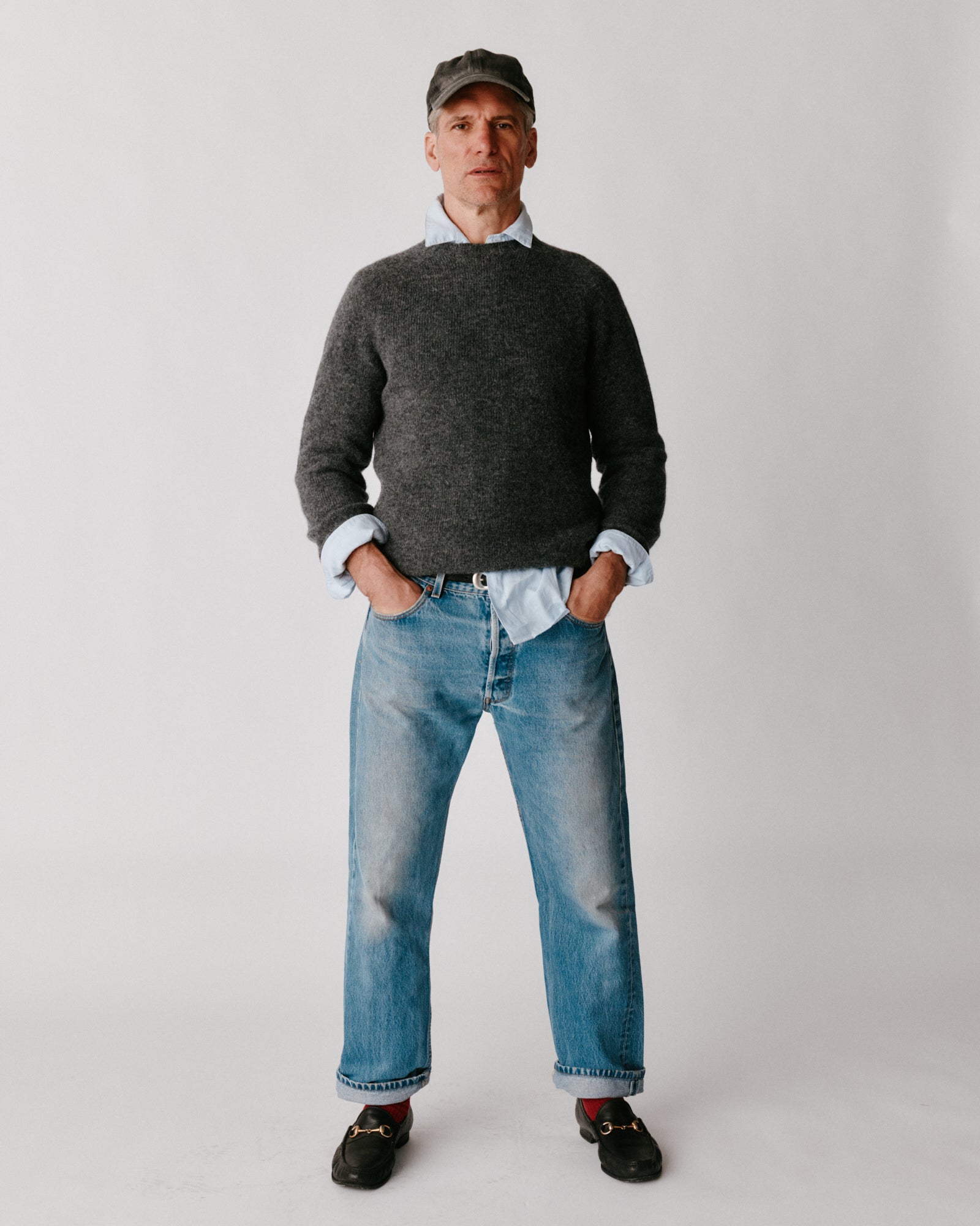 A model wearing a Bosie Harley of Scotland Mens Seamless Saddle Shoulder Shetland Sweater in colour Basalt / Oxford Grey.