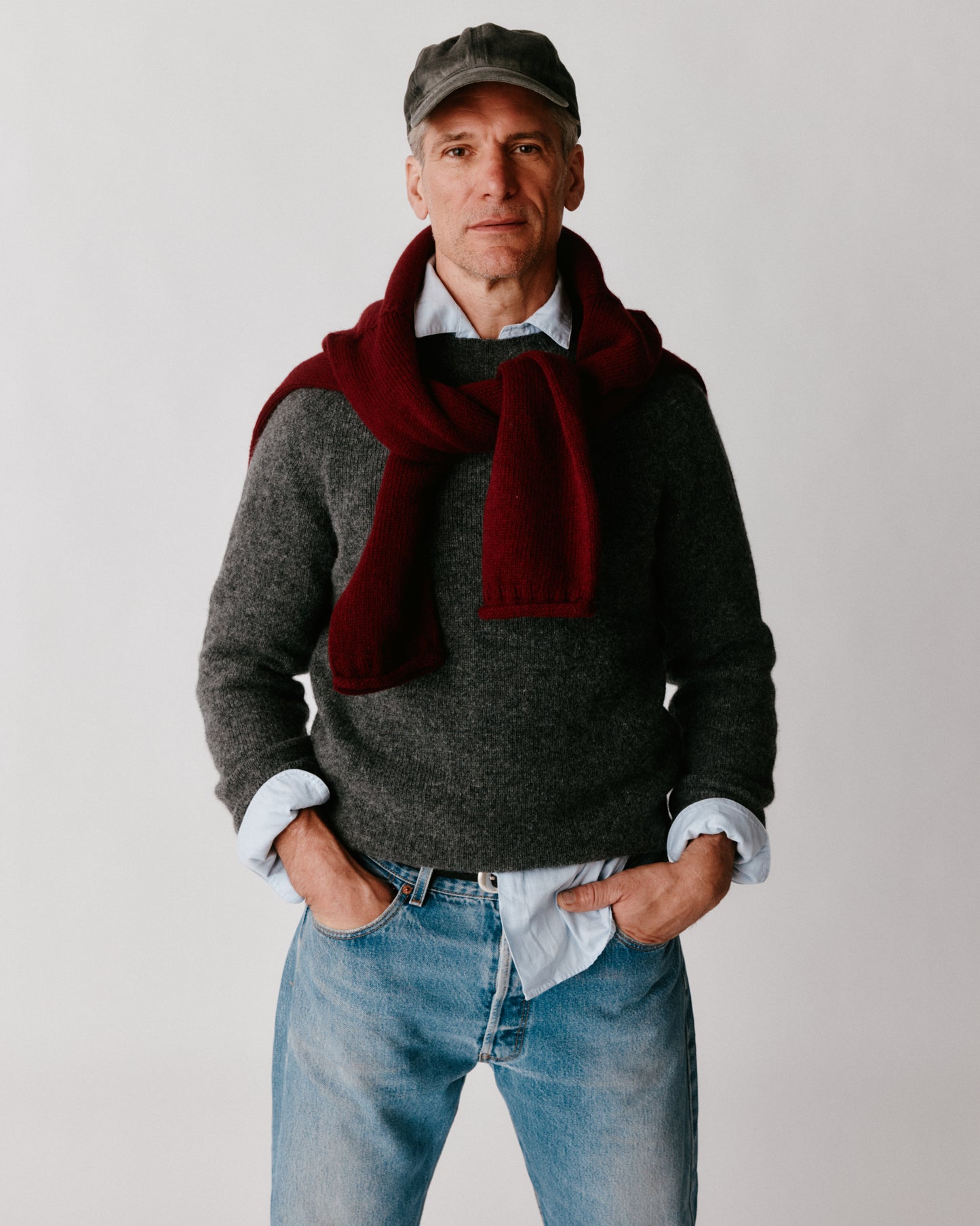 A model wearing a Bosie Harley of Scotland Mens Seamless Saddle Shoulder Shetland Sweater in colour Basalt / Oxford Grey.